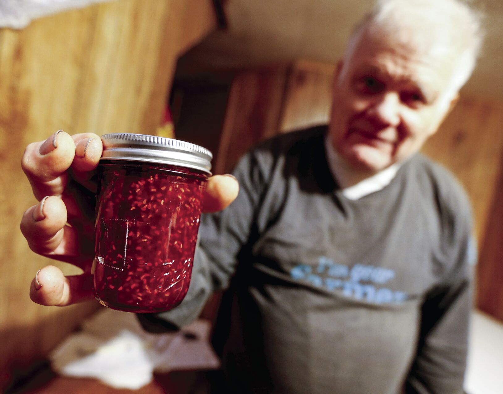Walter Hammerand, of Fennimore, Wis., holds out jam that he sells.    PHOTO CREDIT: Dave Kettering
Telegraph Herald