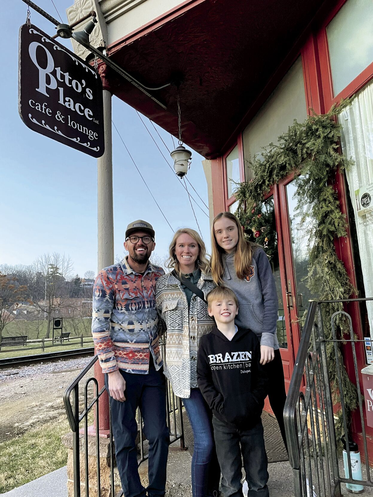 Kevin Scharpf, his wife Lyndsi Scharpf and their children Lloyd, 8, (in the front) and Lola, 10, stand in front of Galena restaurant Otto