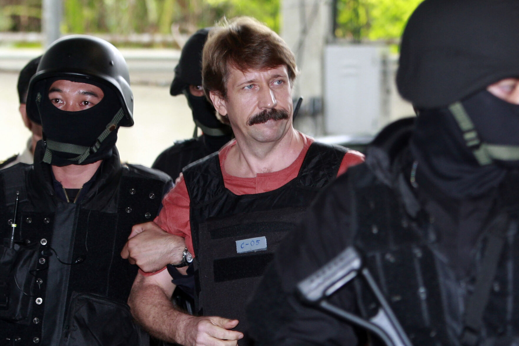<p>FILE - Suspected Russian arms smuggler Viktor Bout, center, is led by armed Thai police commandos as he arrives at the criminal court in Bangkok, Thailand in Oct. 5, 2010. Russia has freed WNBA star Brittney Griner on Thursday in a dramatic high-level prisoner exchange, with the U.S. releasing notorious Russian arms dealer Viktor Bout. (AP Photo/Apichart Weerawong, File)</p>   PHOTO CREDIT: Apichart Weerawong - staff, AP