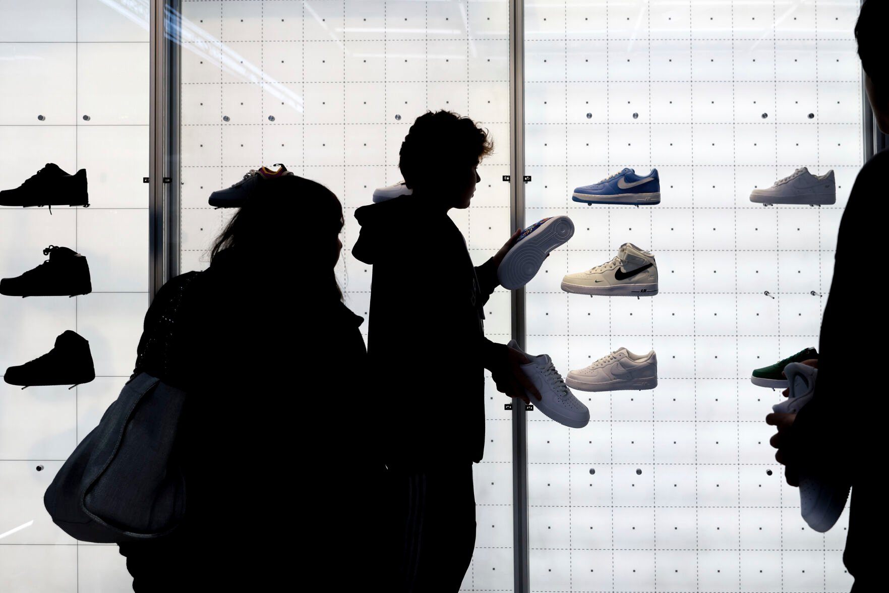 <p>FILE - People shop for shoes in a Nike store on , Nov. 25, 2022, in New York. “Buy now, pay later” services like Affirm, Afterpay and Klarna can sometimes provide a cheaper, more accessible version of credit. These services essentially provide customers an alternative way to pay for purchases over time without going into credit card debt or taking out a traditional personal loan. Travel purchases, such as airfare and vacation rentals, are the fastest-growing segment for buy now, pay later services. However, the Consumer Financial Protection Bureau warns that usage can come at an even greater cost. These services typically entail late fees and can lead travelers to spend more than they otherwise would. (AP Photo/Julia Nikhinson, File)</p>   PHOTO CREDIT: The Associated Press