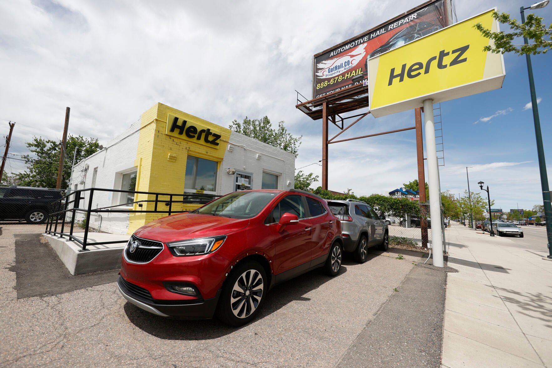 <p>This May 23, 2020, photo shows rental vehicles parked outside a closed Hertz car rental office in south Denver. Hertz says it will pay approximately $168 million by the end of the year to settle the majority of the lawsuits brought against the rental car company by some of its customers who were wrongly accused of stealing cars they had rented. In April Hertz CEO Stephen Scherr, who took over the role in February, said that he was working to fix a glitch in the company’s systems that led to the incidents. (AP Photo/David Zalubowski, file)</p>   PHOTO CREDIT: David Zalubowski 