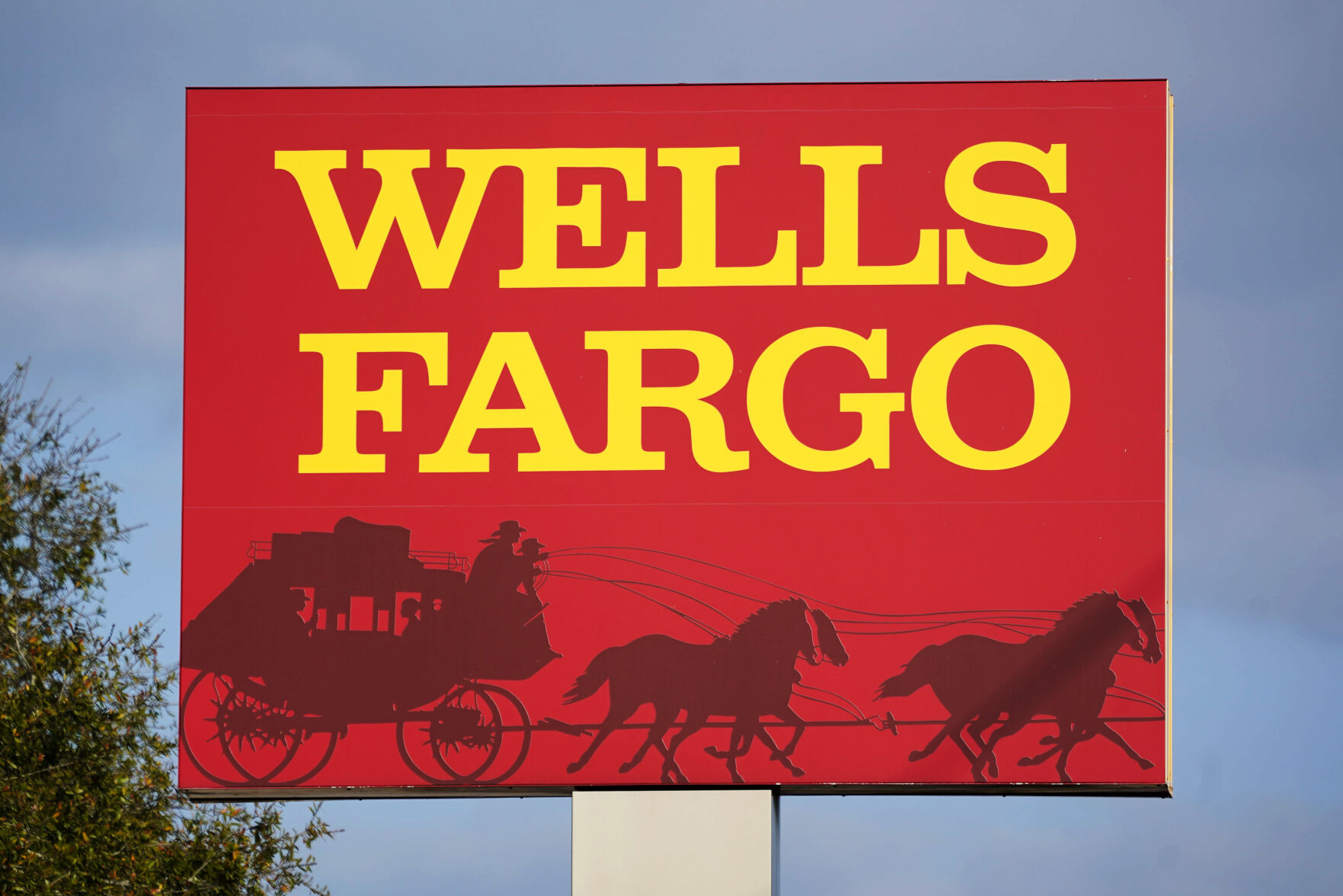 <p>FILE - A Wells Fargo sign stands in front of a branch of the bank in Bradenton, Fla., Tuesday, Feb. 22, 2022. Consumer banking giant Wells Fargo is being ordered to pay $3.7 billion in fines and refunds to customers by U.S. government regulators, the largest fine to date against the bank. (AP Photo/Gene J. Puskar, File)</p>   PHOTO CREDIT: Gene J. Puskar 