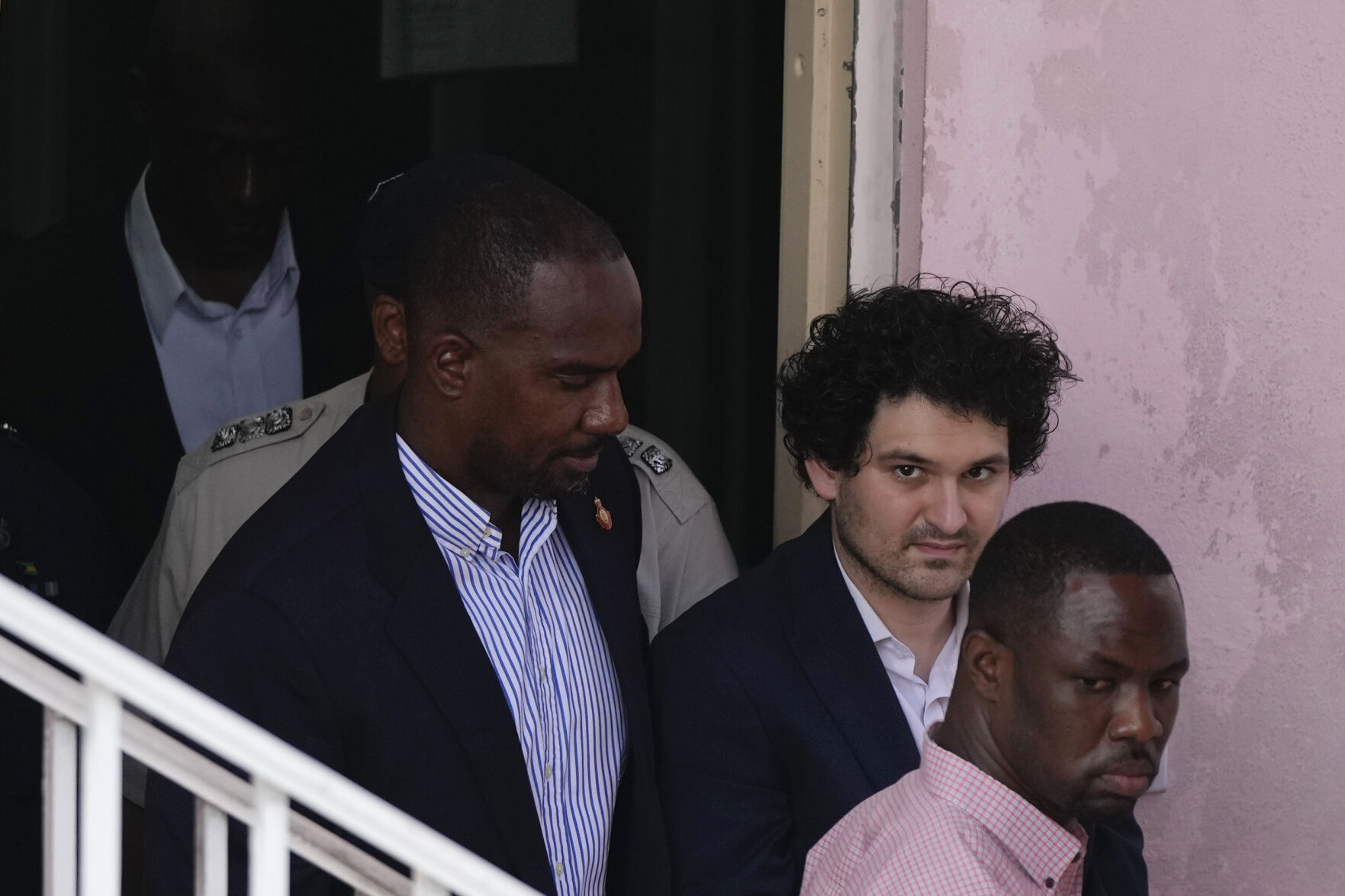 <p>FTX founder Sam Bankman-Fried, second right, is escorted out of Magistrate Court toward a Corrections van, following a hearing in Nassau, Bahamas, Monday, Dec. 19, 2022. (AP Photo/Rebecca Blackwell)</p>   PHOTO CREDIT: Rebecca Blackwell - staff, AP