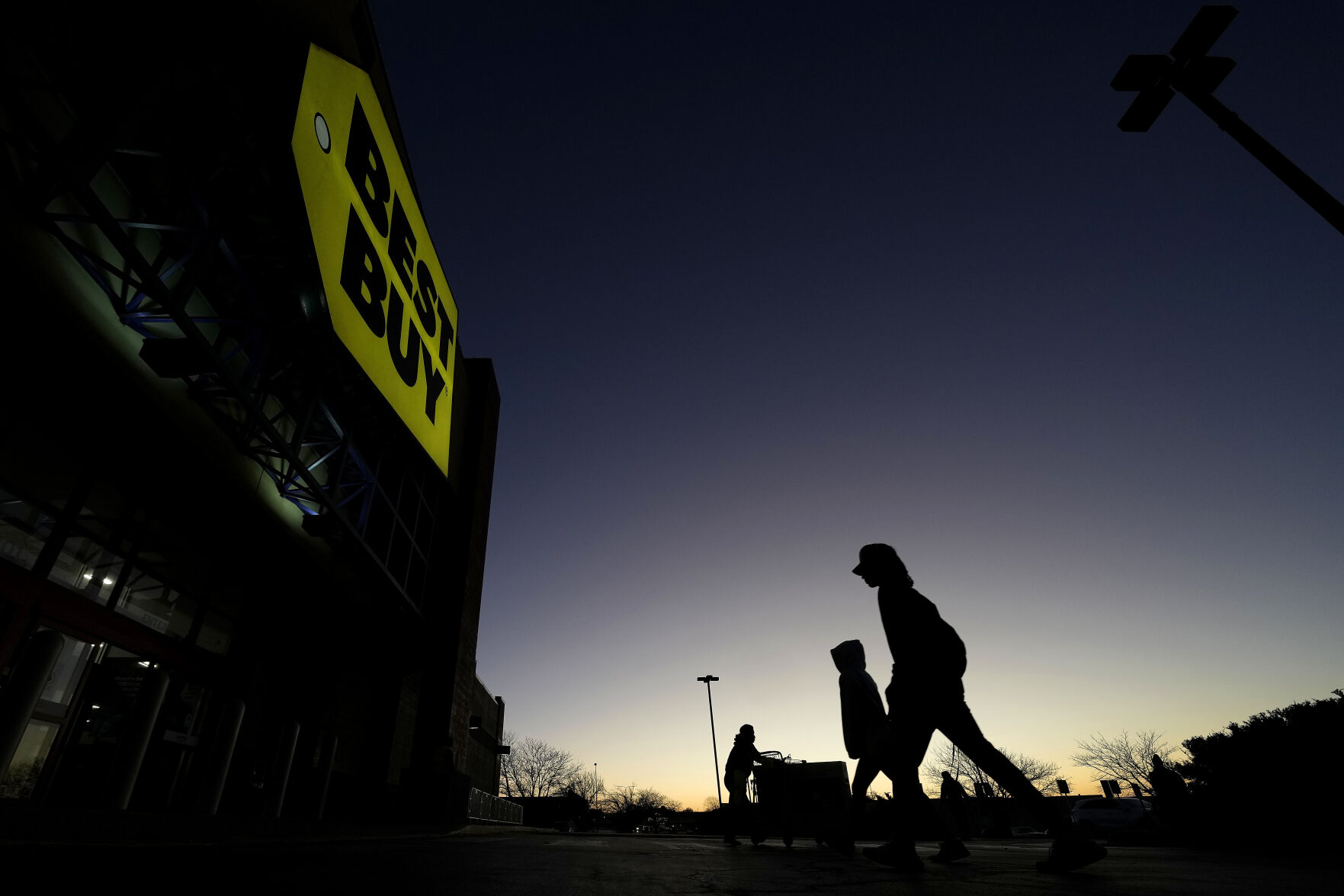<p>FILE - Shoppers are silhouetted against the sky as they arrives for a sale at a Best Buy store Friday, Nov. 25, 2022, in Overland Park, Kan. On Friday the Commerce Department issues its November report on consumer spending. The report contains a measure of inflation that is closely watched by the Federal Reserve, which has aggressively tried to corral inflation this year by raising its key lending rate seven times. (AP Photo/Charlie Riedel, File)</p>   PHOTO CREDIT: Charlie Riedel - staff, AP