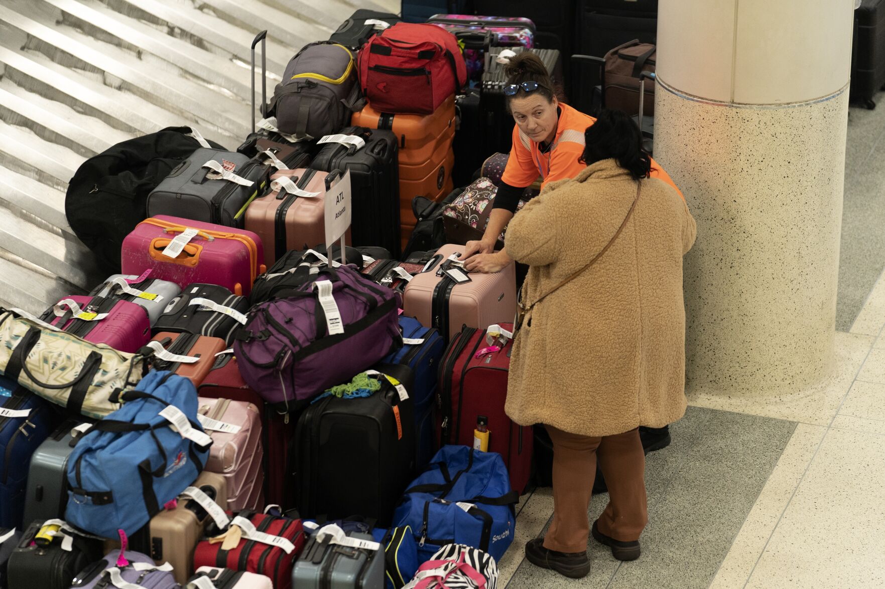 <p>A Southwest Airlines employee helps a traveler search for bags amongst hundreds of other checked bags at baggage claim at Midway International Airport as Southwest continues to cancel thousands of flights across the country Wednesday, Dec. 28, 2022, in Chicago. (AP Photo/Erin Hooley)</p>   PHOTO CREDIT: The Associated Press