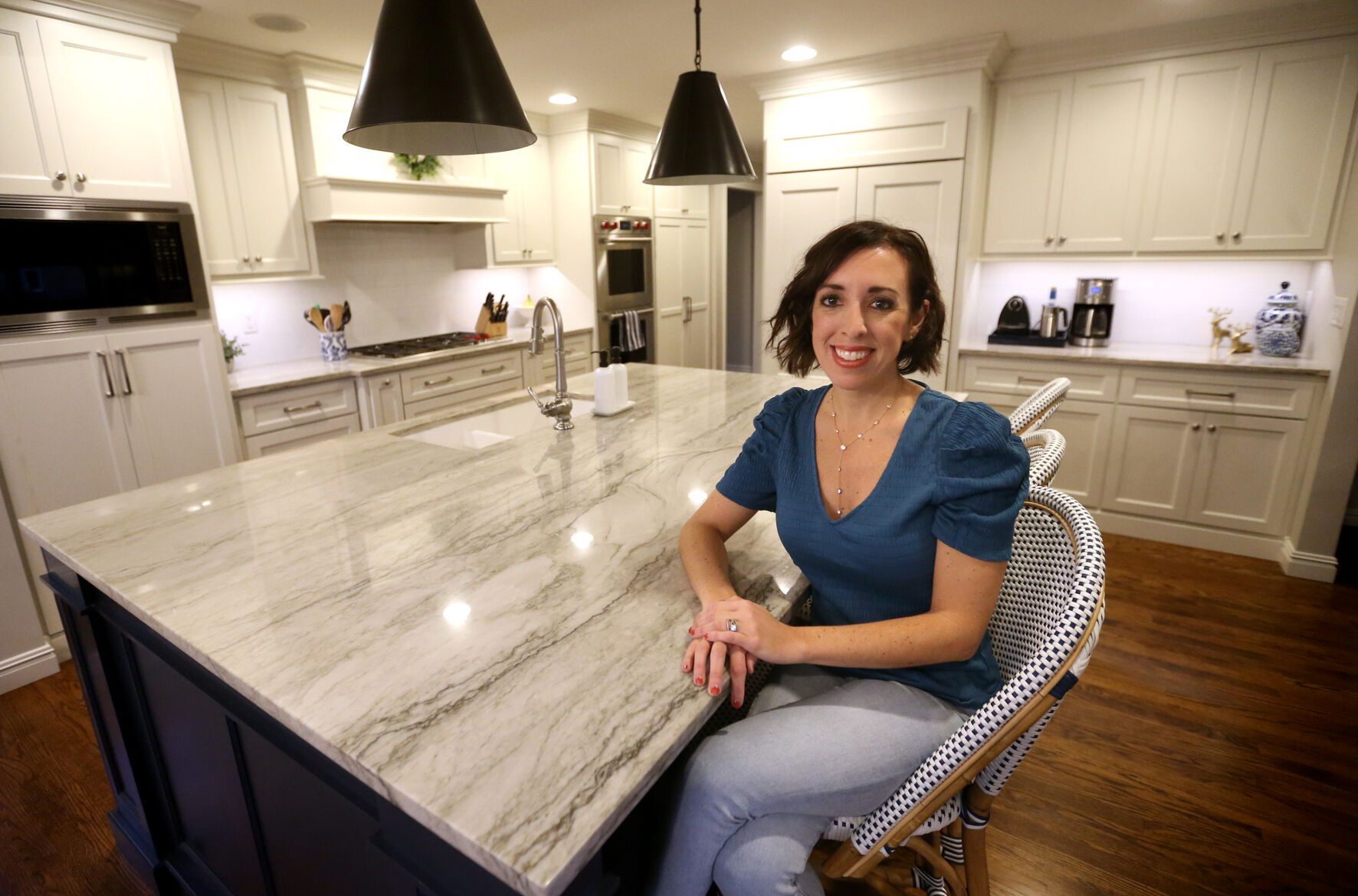 Nicole Powers, who owns Simply Organized Dubuque, sits at her home in Dubuque.    PHOTO CREDIT: JESSICA REILLY