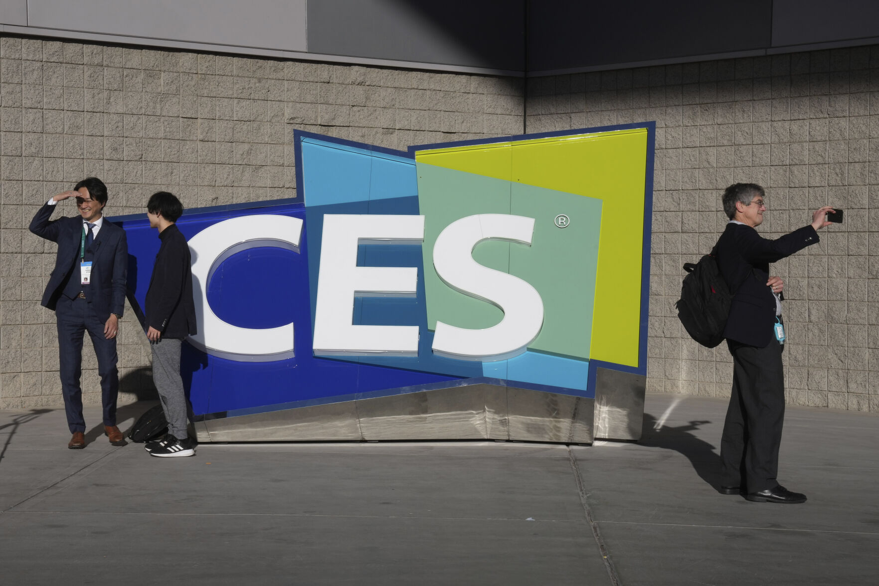 <p>FILE - People take pictures in front of a sign during the CES tech show on Jan. 6, 2022, in Las Vegas. CES is returning to Las Vegas in January 2023 with the hope that it inches closer to how it looked before the pandemic. (AP Photo/Joe Buglewicz, File)</p>   PHOTO CREDIT: Joe Buglewicz 
