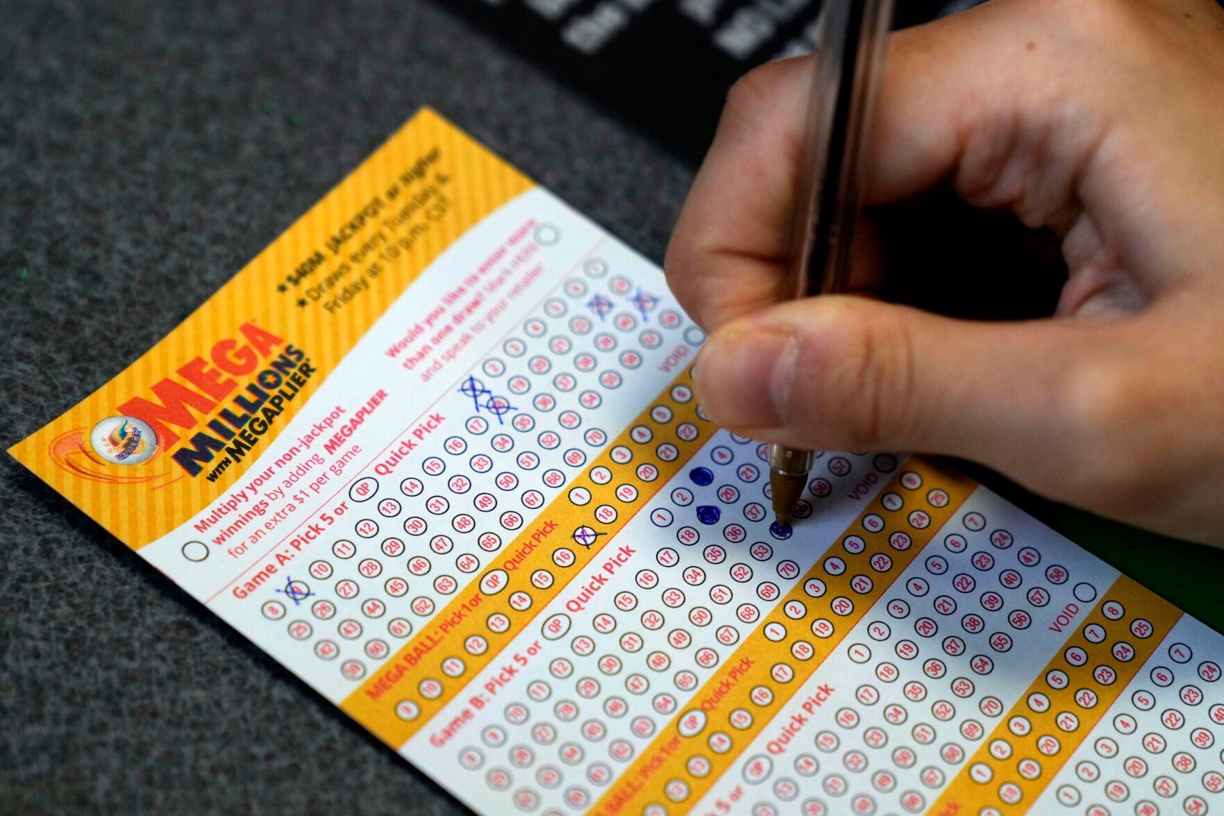 <p>A customer fills out a Mega Millions lottery ticket at a convenience store Tuesday, Jan. 3, 2023, in Northbrook, Ill. (AP Photo/Nam Y. Huh)</p>   PHOTO CREDIT: Nam Y. Huh 