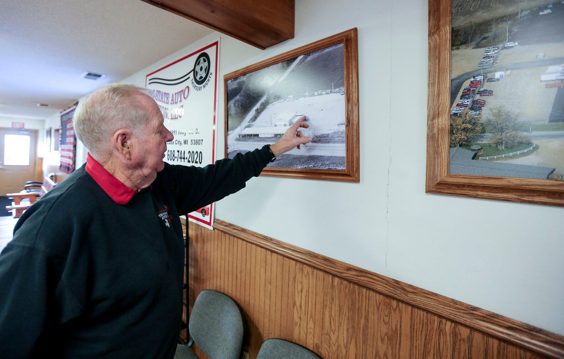 Jerry Brogley looks at an aerial photo taken in the 1970s of the Tri-State Auto Auction, located in Cuba City, Wis.    PHOTO CREDIT: Dave Kettering
