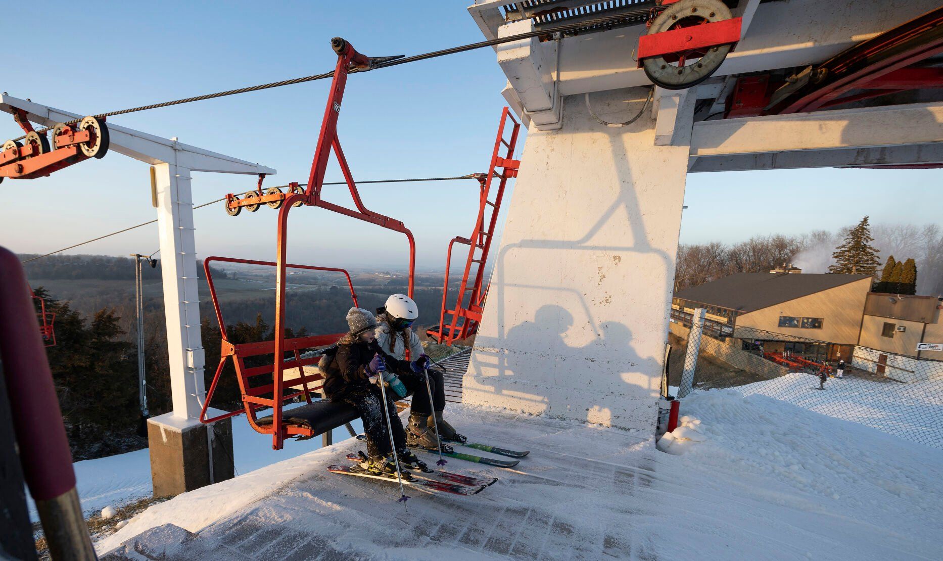 Two young skiers exit the triple chairlift at Sundown Mountain Resort in Dubuque on Friday, Jan. 6, 2023    PHOTO CREDIT: Stephen Gassman