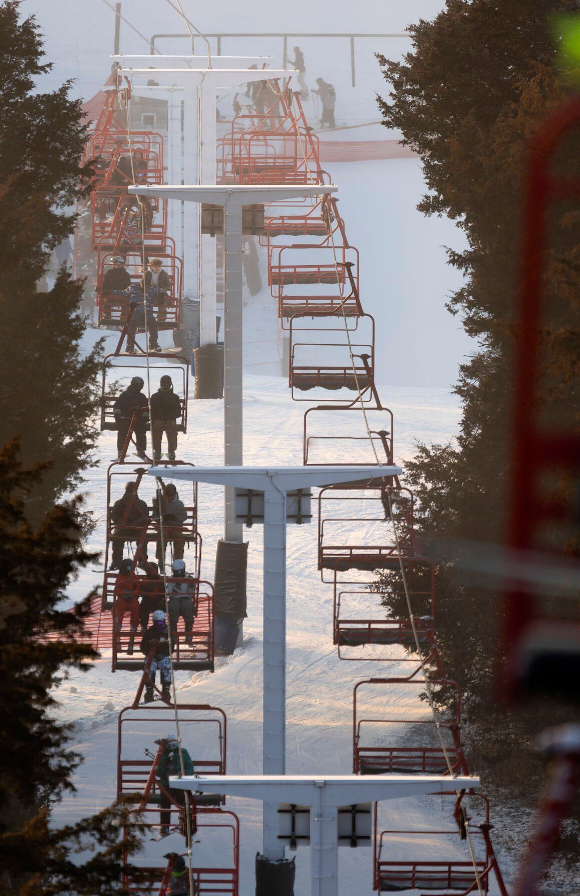 Skiers and snowboarders ride the triple chairlift at Sundown Mountain Resort in Dubuque on Friday, Jan. 6, 2023    PHOTO CREDIT: Stephen Gassman