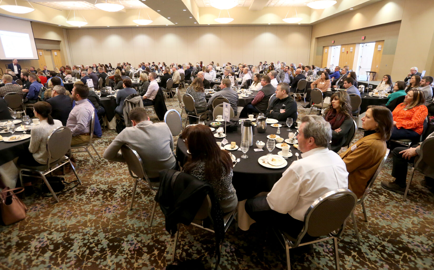 Attendees listen to keynote speaker Elliot Eisenberg during the Dubuque Area Chamber of Commerce Forecast Luncheon at Grand River Center in Dubuque on Thursday, Jan. 19, 2023.    PHOTO CREDIT: JESSICA REILLY