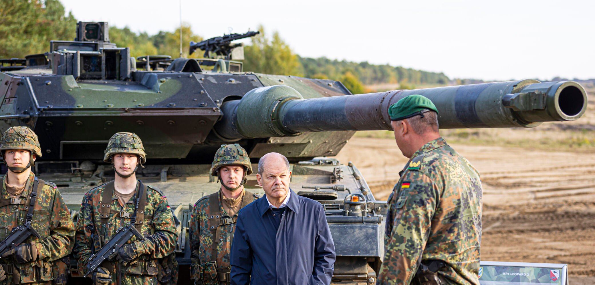 <p>FILE - German Chancellor Olaf Scholz stands with German army Bundeswehr soldiers at a "Leopard 2" main battle tank during a training and instruction exercise in in Ostenholz, Germany, Monday, Oct. 17, 2022. Scholz is expected to announce Wednesday, Jan. 25, 2023 that his government will approve supplying German-made battle tanks to Ukraine. (Moritz Frankenberg/dpa via AP, File)</p>   PHOTO CREDIT: Moritz Frankenberg - foreign subscriber, DPA