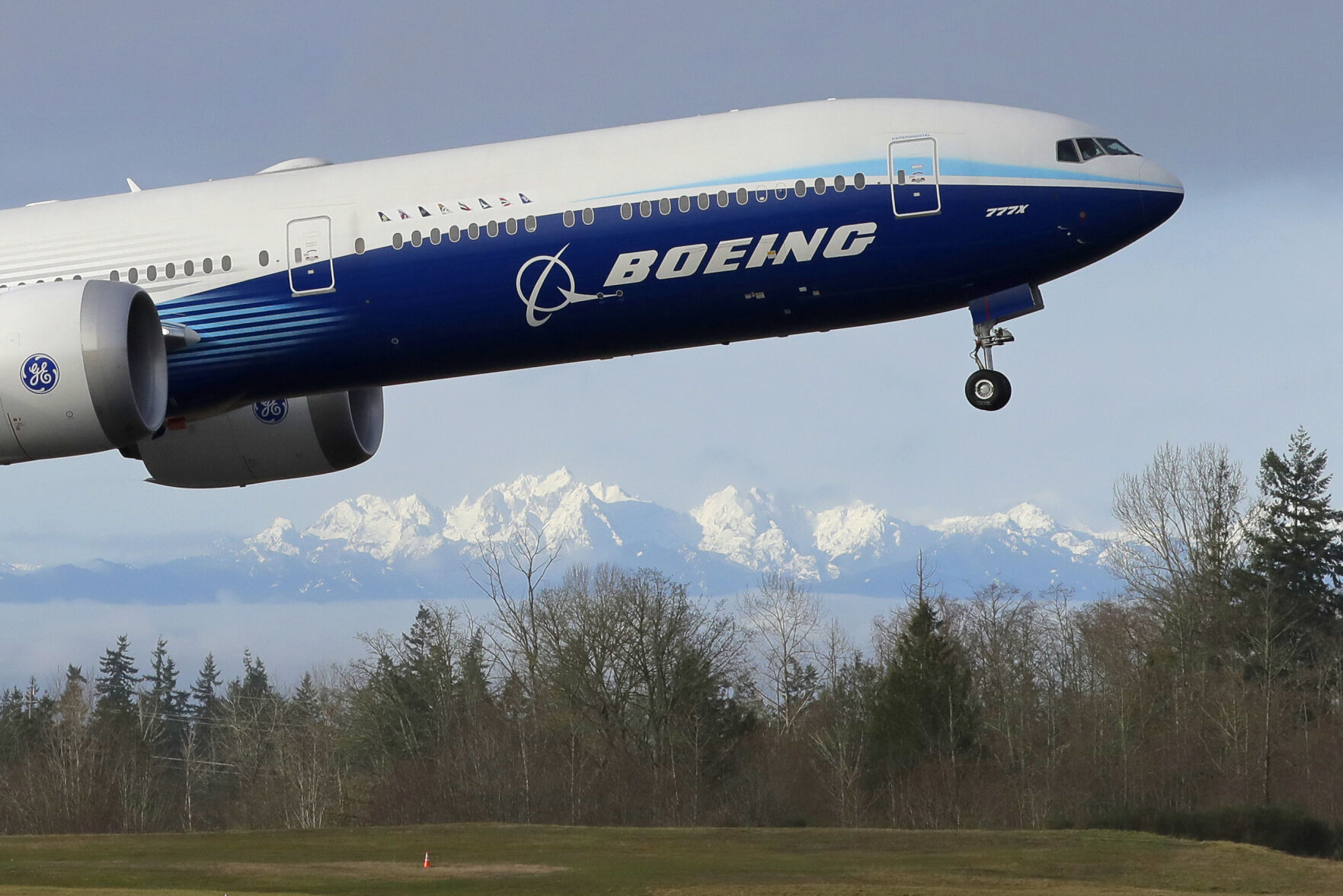 <p>FILE - In this Jan. 25, 2020, file photo a Boeing 777X airplane takes off on its first flight with the Olympic Mountains in the background at Paine Field in Everett, Wash. Boeing Co. reports earnings on Wednesday, Jan. 25, 2023. (AP Photo/Ted S. Warren, File)</p>   PHOTO CREDIT: Ted S. Warren 