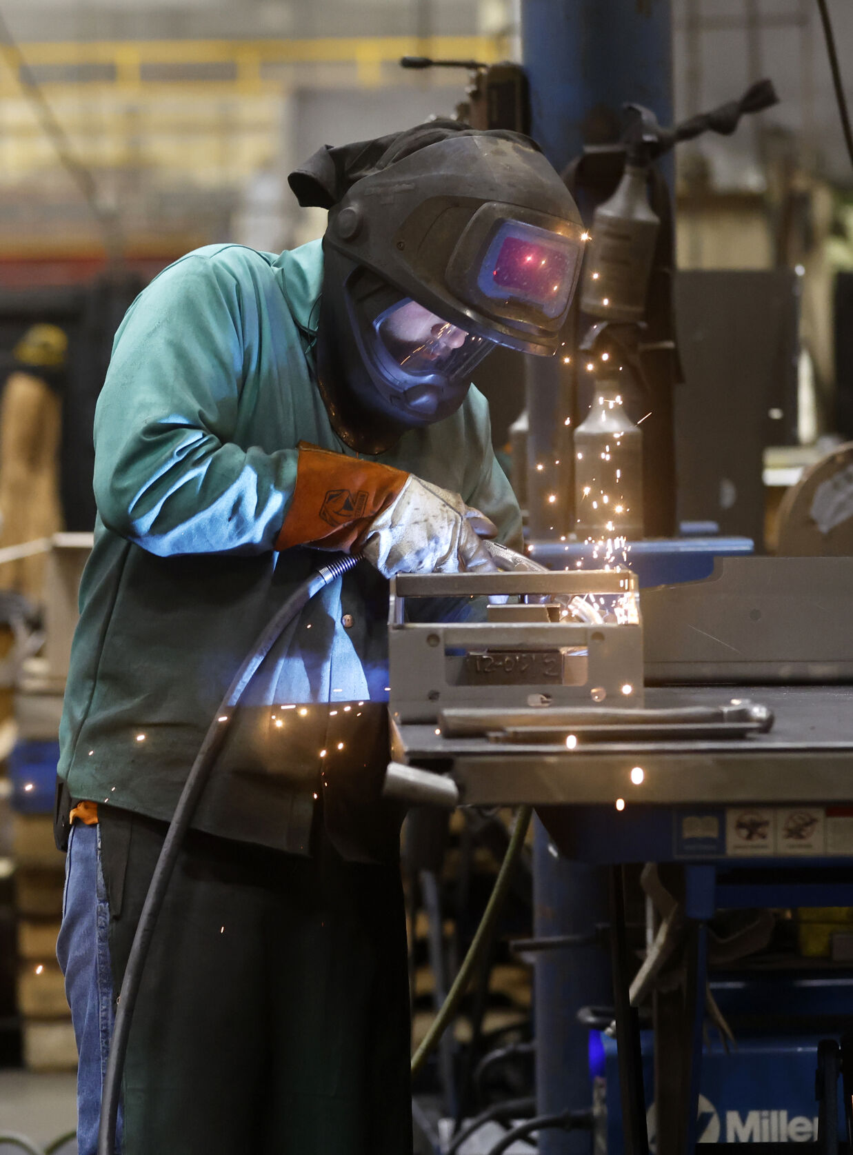 Cole Lineburg welds product at Mi-T-M Corp. in Peosta, Iowa. Over the past 50 years, Mi-T-M has grown tremendously, becoming a major force in Peosta’s business community and employing around 400 people.    PHOTO CREDIT: JESSICA REILLY
Telegraph Herald