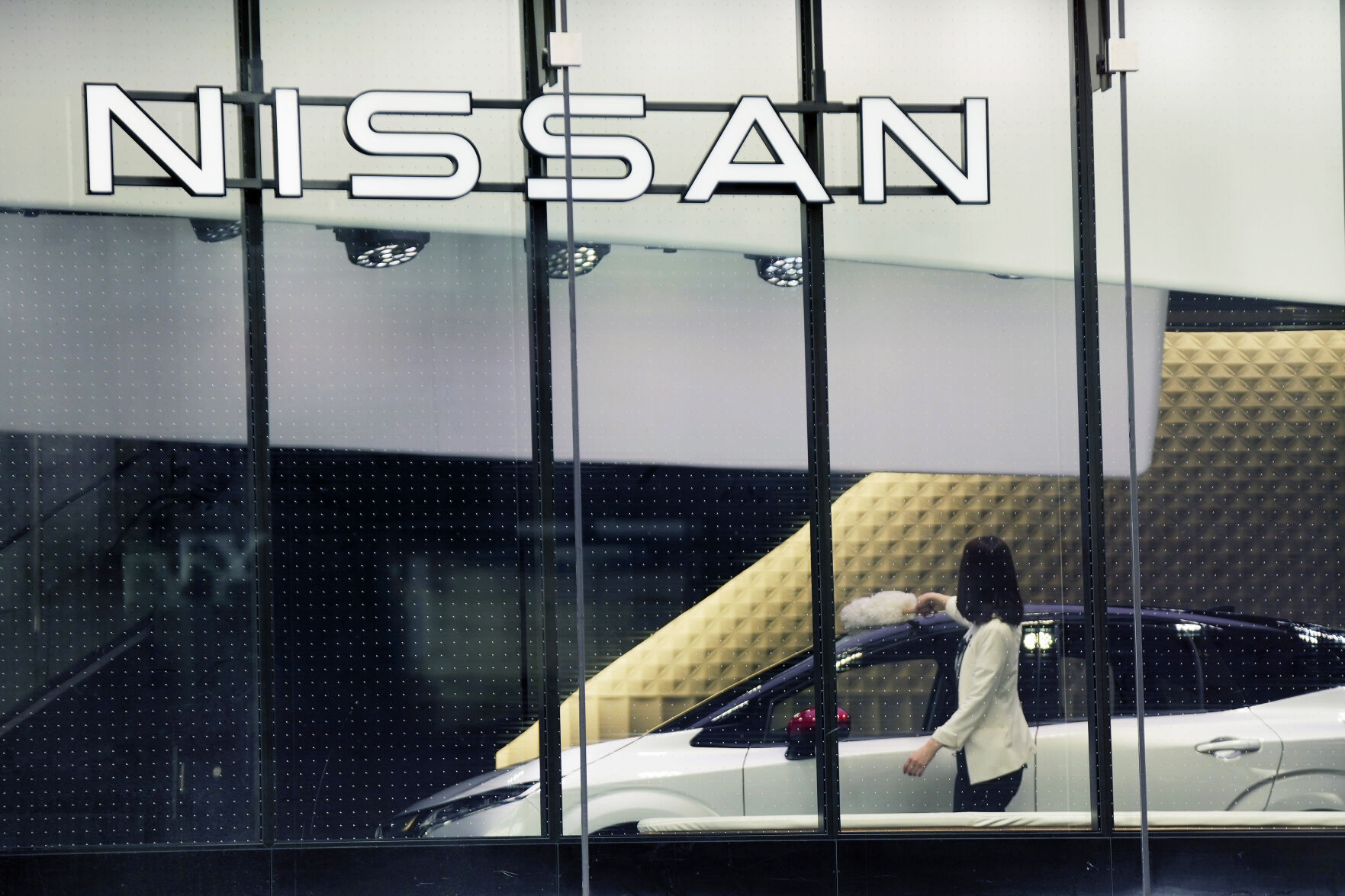 <p>FILE - A staff of Nissan car showroom wipes a car on Jan. 31, 2022, in Tokyo. Nissan reported a 55% jump in October-December profit Thursday, Feb. 9, 2023, as the Japanese automaker seeks to embark on a less bumpy journey with its French alliance partner Renault. (AP Photo/Eugene Hoshiko, File)</p>   PHOTO CREDIT: Eugene Hoshiko 