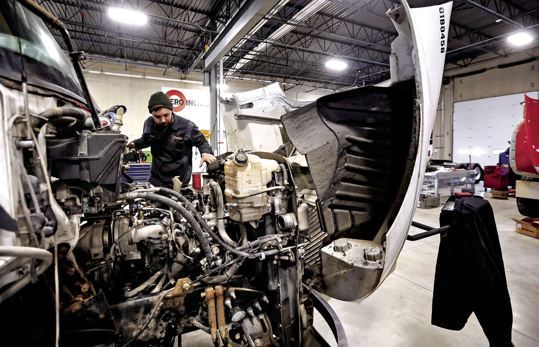 Erik Lotter works on an engine at Thompson Truck & Trailer in Dubuque on Friday.    PHOTO CREDIT: JESSICA REILLY