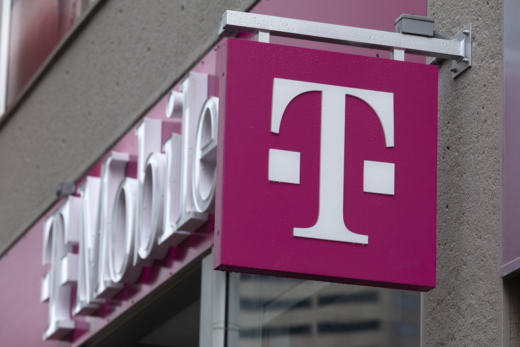 <p>FILE - The T-Mobile logo is seen on a storefront, on Oct. 14, 2022, in Boston. Customers of the wireless provider reported widespread service outages in the U.S. late Monday, Feb. 13, 2023, according to websites tracking service interruptions. (AP Photo/Michael Dwyer, File)</p>   PHOTO CREDIT: Michael Dwyer 