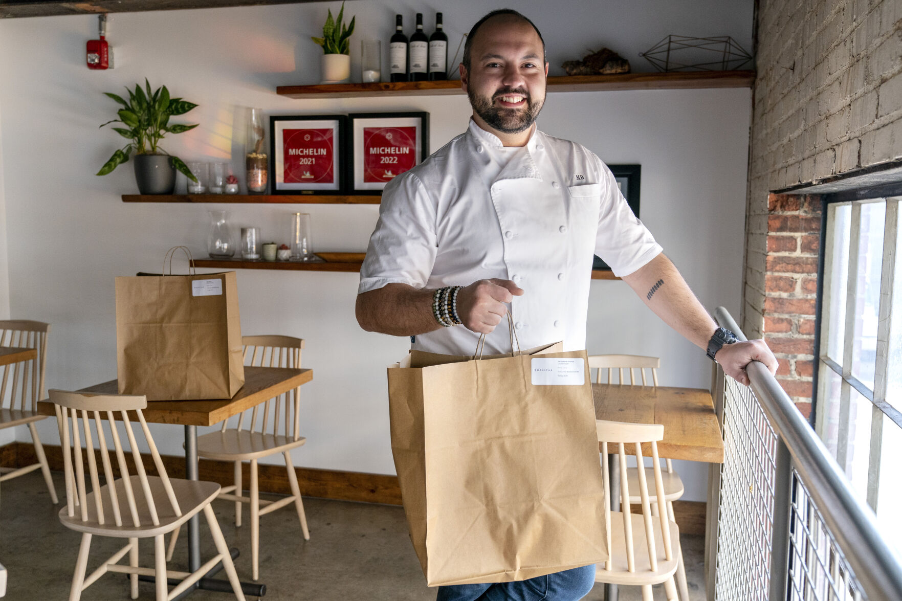 <p>Matt Baker, chef and owner of Gravitas, poses for a portrait inside the restaurant, Tuesday, Feb. 14, 2023, in Washington. Gravitas has a subscription service offering a monthly meal for two. (AP Photo/Jacquelyn Martin)</p>   PHOTO CREDIT: Jacquelyn Martin 