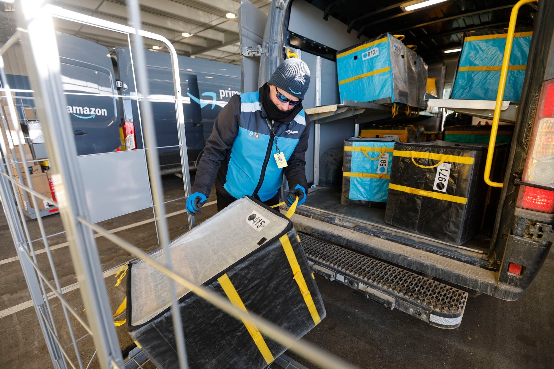 Richard Waddington loads packages into vehicles at Amazon in Dubuque on Tuesday, Feb. 21, 2023.    PHOTO CREDIT: JESSICA REILLY