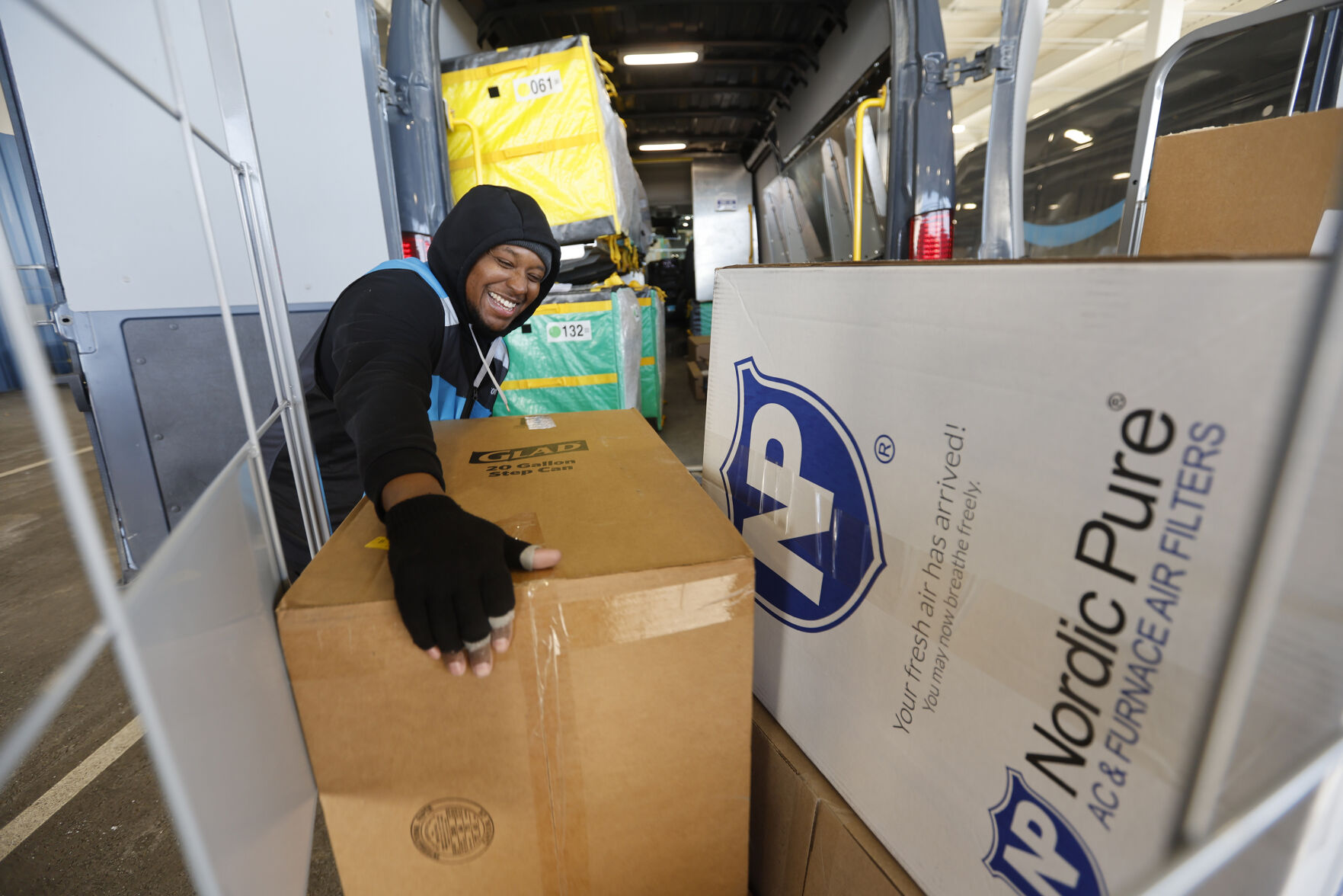 Frederick Overton loads packages into vehicles at Amazon in Dubuque on Tuesday, Feb. 21, 2023.    PHOTO CREDIT: JESSICA REILLY