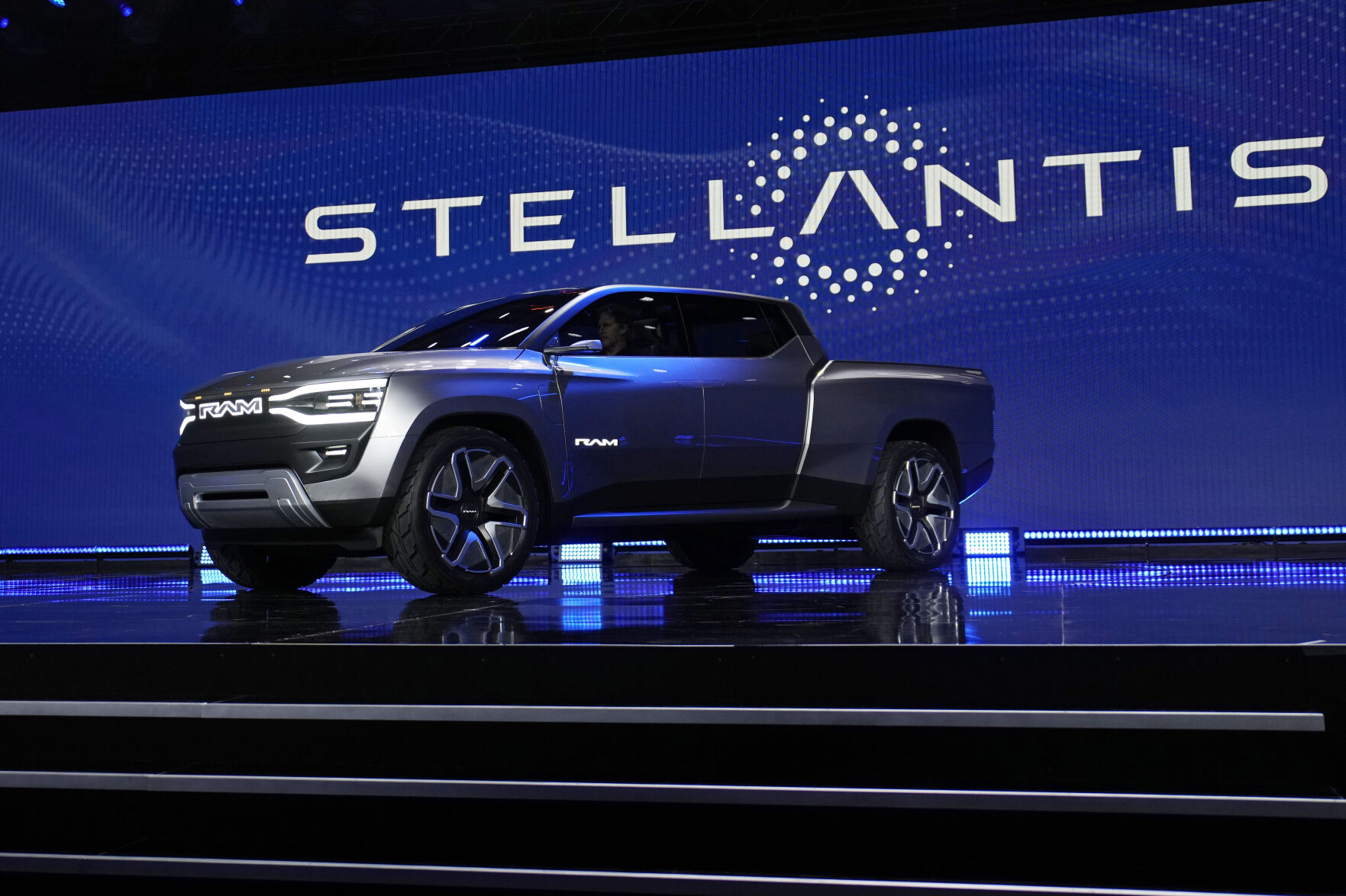 <p>FILE - The Ram 1500 Revolution electric battery powered pickup truck is displayed on stage during the Stellantis keynote at the CES tech show on Jan. 5, 2023, in Las Vegas. Automaker Stellantis has reported its earnings grew in 2022 from a year earlier as it pressed an industrywide strategy to shift into electric vehicles, leading to a jump in sales. The company said Wednesday, Feb. 22, 2023, that net revenue of 179.6 billion euros was up 18% from 2021. It reported net profit of 16.8 billion, up 26% from 2021. (AP Photo/John Locher)</p>   PHOTO CREDIT: John Locher 
