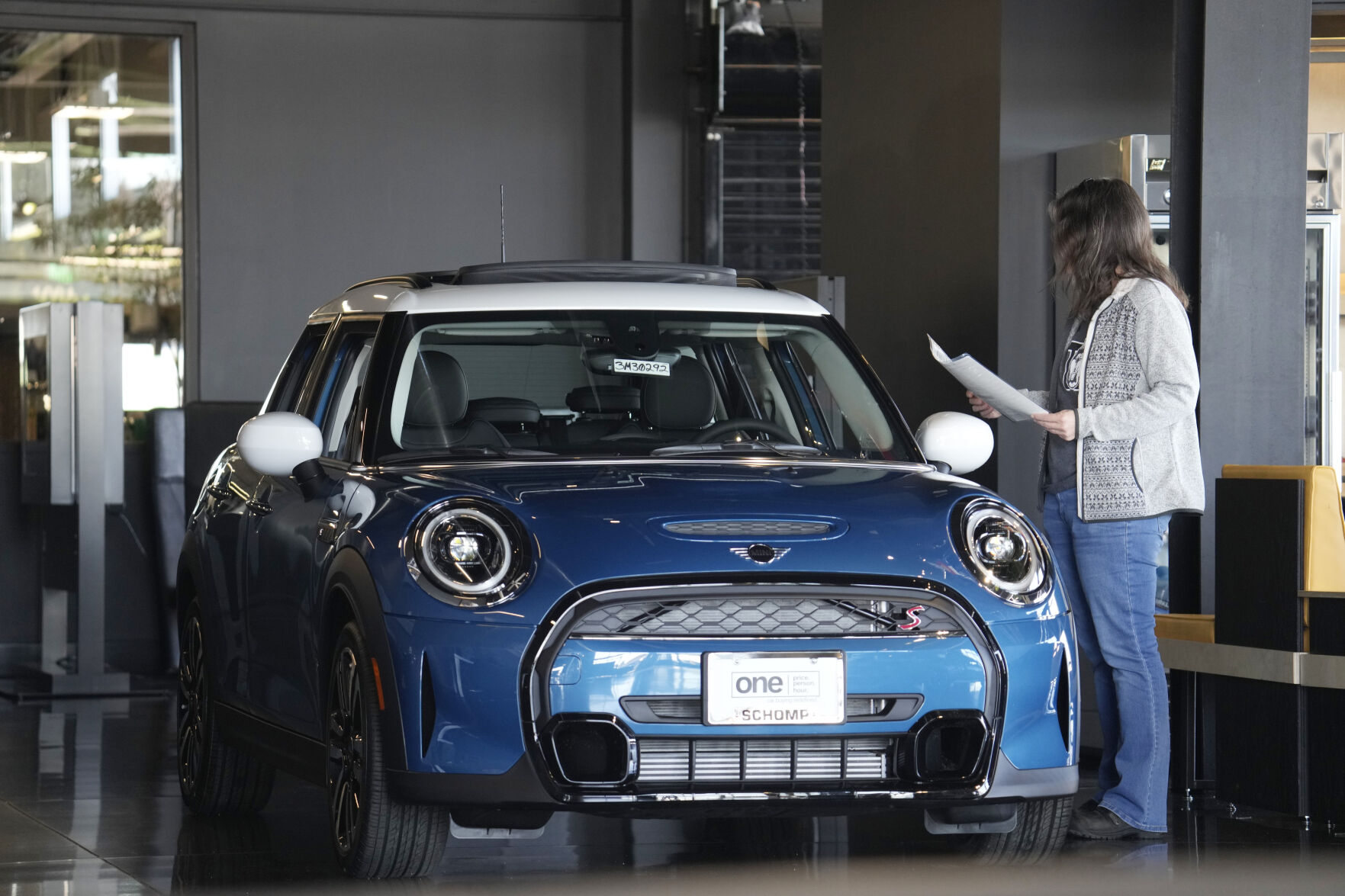 <p>A potential buyer looks over a 2023 Cooper S sedan on the floor of a Mini dealership Friday, Feb. 17, 2023, in Highlands Ranch, Colo. Over the past year, the Fed has raised its key short-term rate eight times, causing many kinds of consumer and business loans, including auto loans, to become more expensive. (AP Photo/David Zalubowski)</p>   PHOTO CREDIT: David Zalubowski 