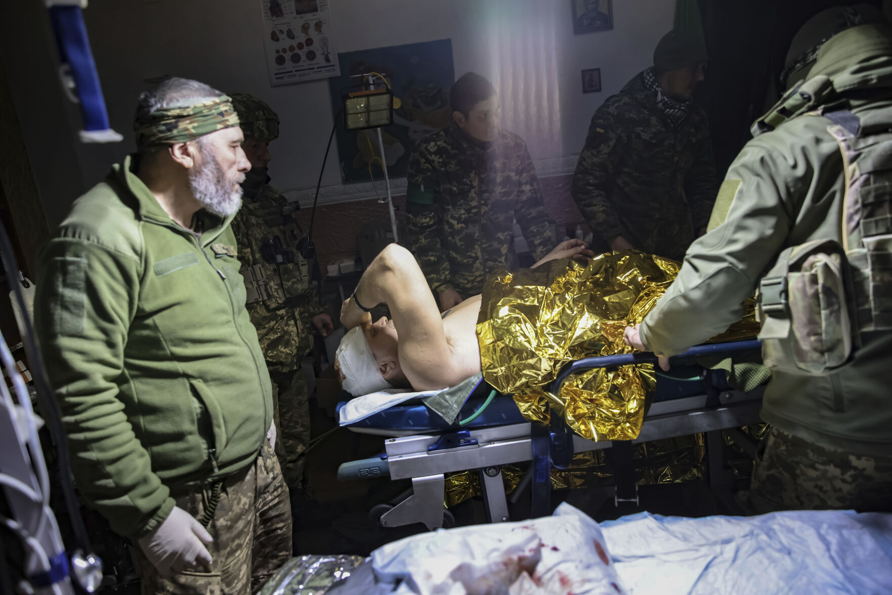 <p>Medics give the first aid to a wounded Ukrainian soldier near Bakhmut, the site of the heaviest battles with the Russian troops, Donetsk region, Ukraine, Monday, Feb. 27, 2023. (AP Photo/Yevhen Titov)</p>   PHOTO CREDIT: Yevhen Titov - stringer, AP