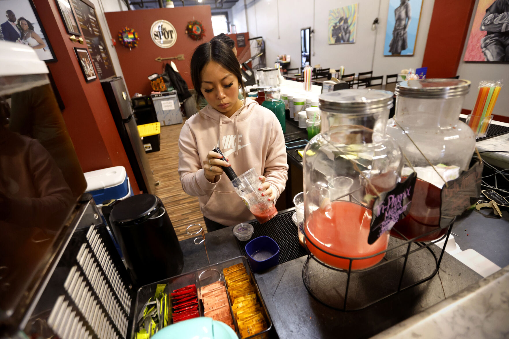 Jennifer Bardon makes a drink at The Spot Nutrition in Dubuque.    PHOTO CREDIT: Jessica Reilly
