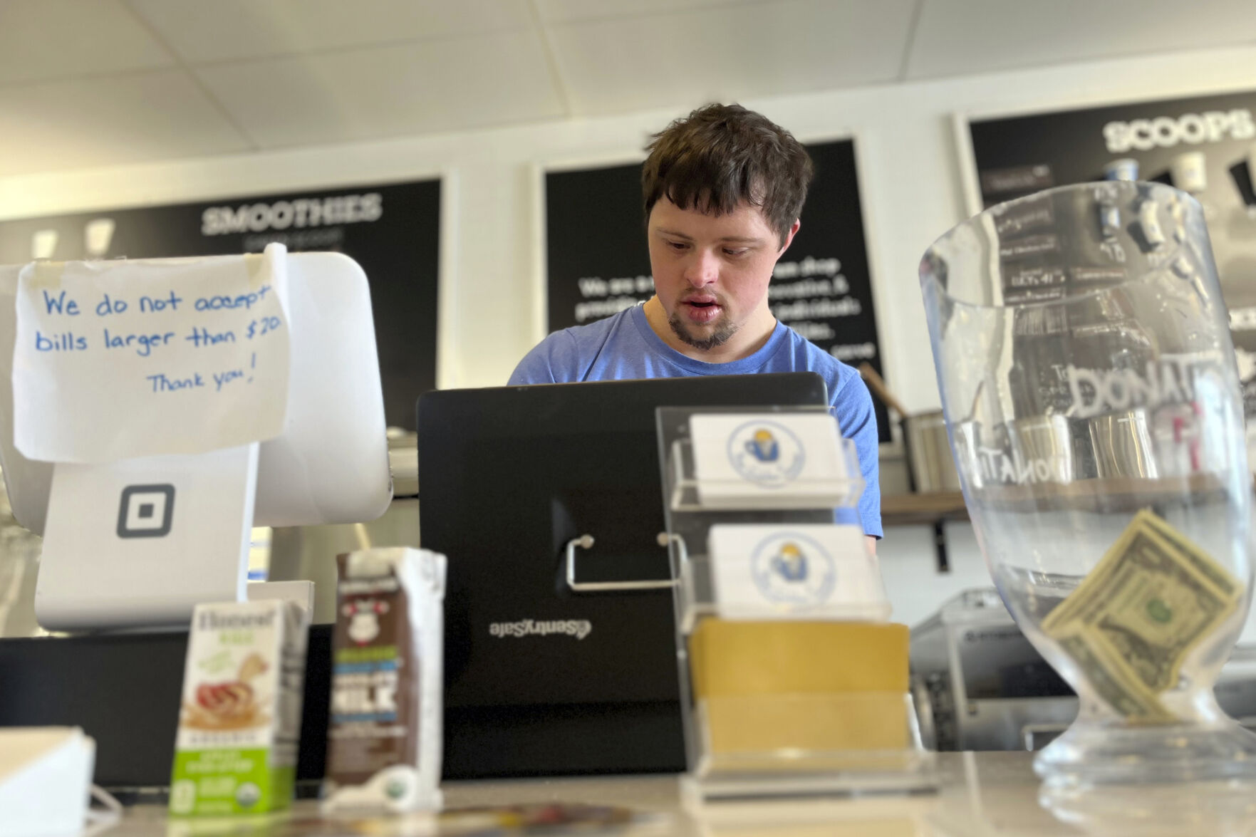 <p>Patrick Chapman, 27, prepares for customers Thursday, March 2, 2023, at The Golden Scoop, an Overland Park, Kan., ice cream and coffee shop that employs workers with developmental disabilities, paying them more than minimum wage. But some disabled workers employed at so-called sheltered workshops are earning far less than minimum wage, an issue that has captured the attention of lawmakers in the state. Disability rights advocates say the practice is discriminatory and more than a dozen states have banned such wages. (AP Photo/Heather Hollingsworth)</p>   PHOTO CREDIT: Heather Hollingsworth