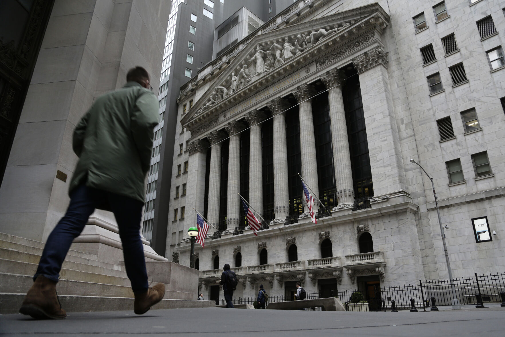 <p>People pass the front of the New York Stock Exchange in New York, on Wednesday, March 22, 2023. European shares have opened mixed after a day of gains in Asia ahead of a decision by the Federal Reserve on interest rates. (AP Photo/Peter Morgan</p>   PHOTO CREDIT: Peter Morgan -