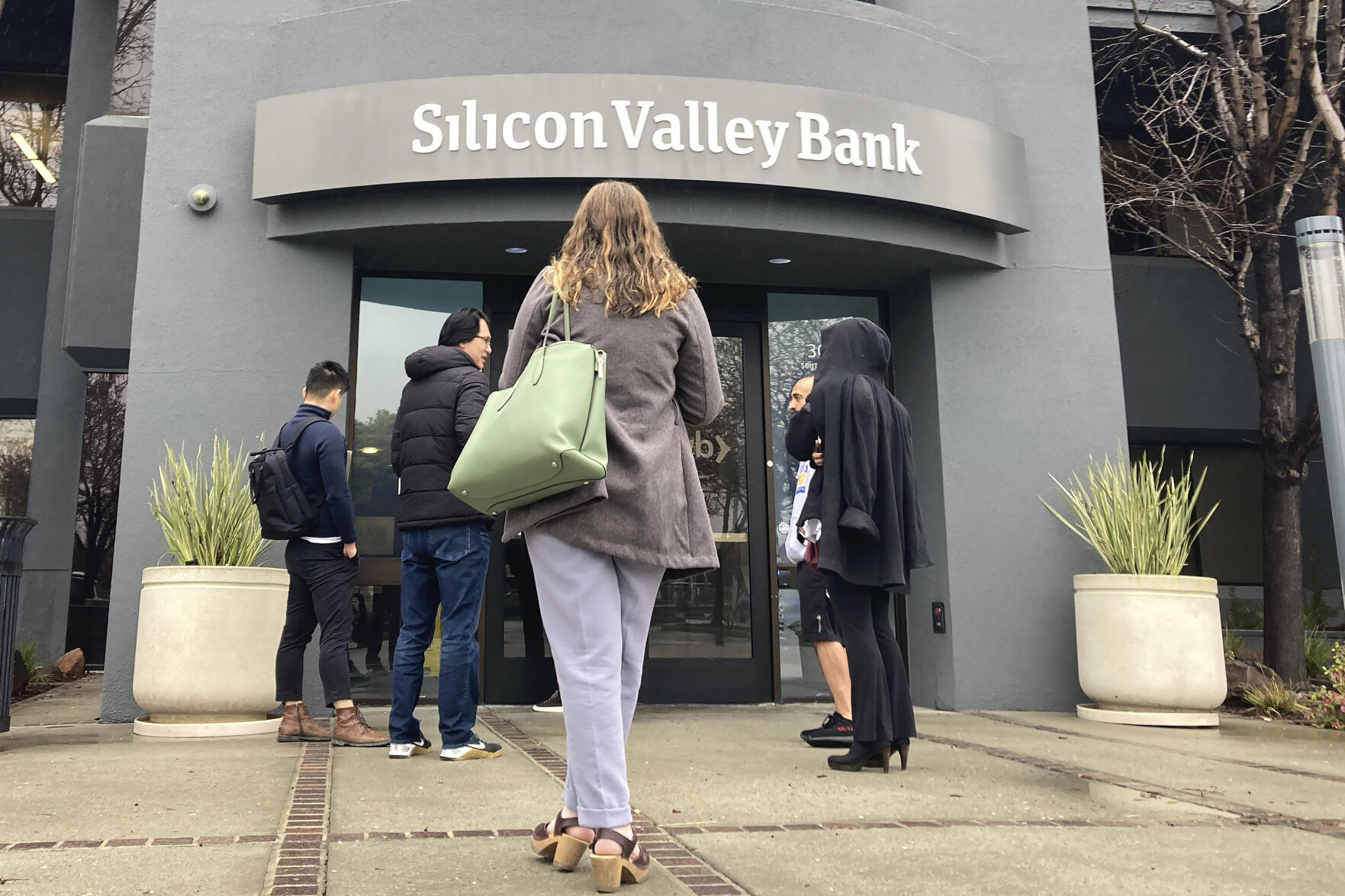 <p>File - People stand outside of an entrance to Silicon Valley Bank in Santa Clara, Calif., Friday, March 10, 2023. The collapse of Silicon Valley Bank and Signature Bank, and the bailout of First Republic, was a jolt for small businesses of all stripes, spurring many to scrutinize their banking services and mull whether or not they should make changes to ensure their money is safe. (AP Photo/Jeff Chiu, File)</p>   PHOTO CREDIT: Jeff Chiu 