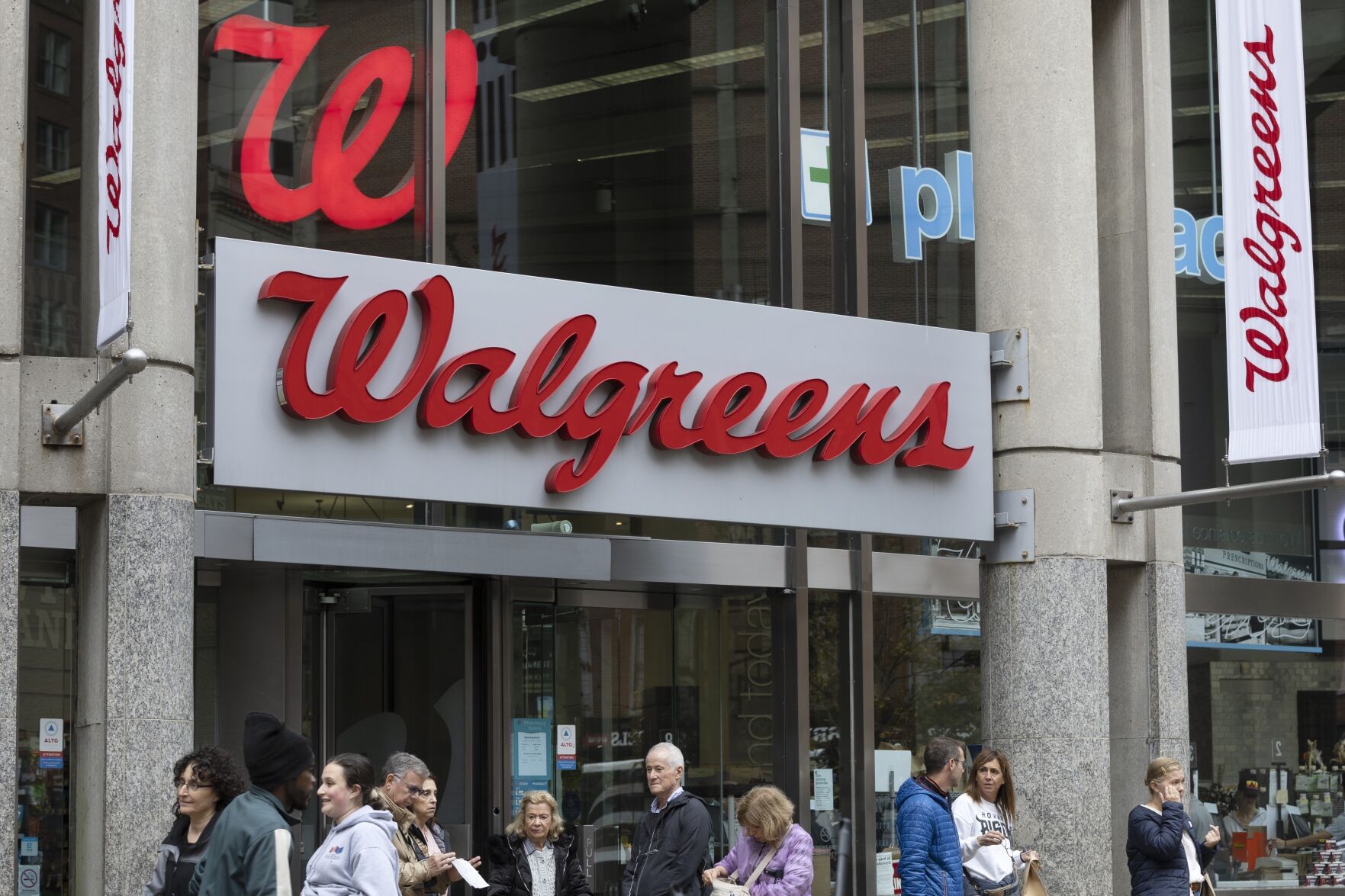 <p>FILE - The entrance to a Walgreens is seen on Oct. 14, 2022, in Boston. A decline in COVID-19 vaccinations and another opioid settlement cut into Walgreens second-quarter earnings, but the drugstore chain still delivered better-than-expected results. Walgreens said Tuesday, March 28, 2023, that it recorded 2.4 million vaccinations in its recently completed fiscal second quarter. (AP Photo/Michael Dwyer, File)</p>   PHOTO CREDIT: Michael Dwyer