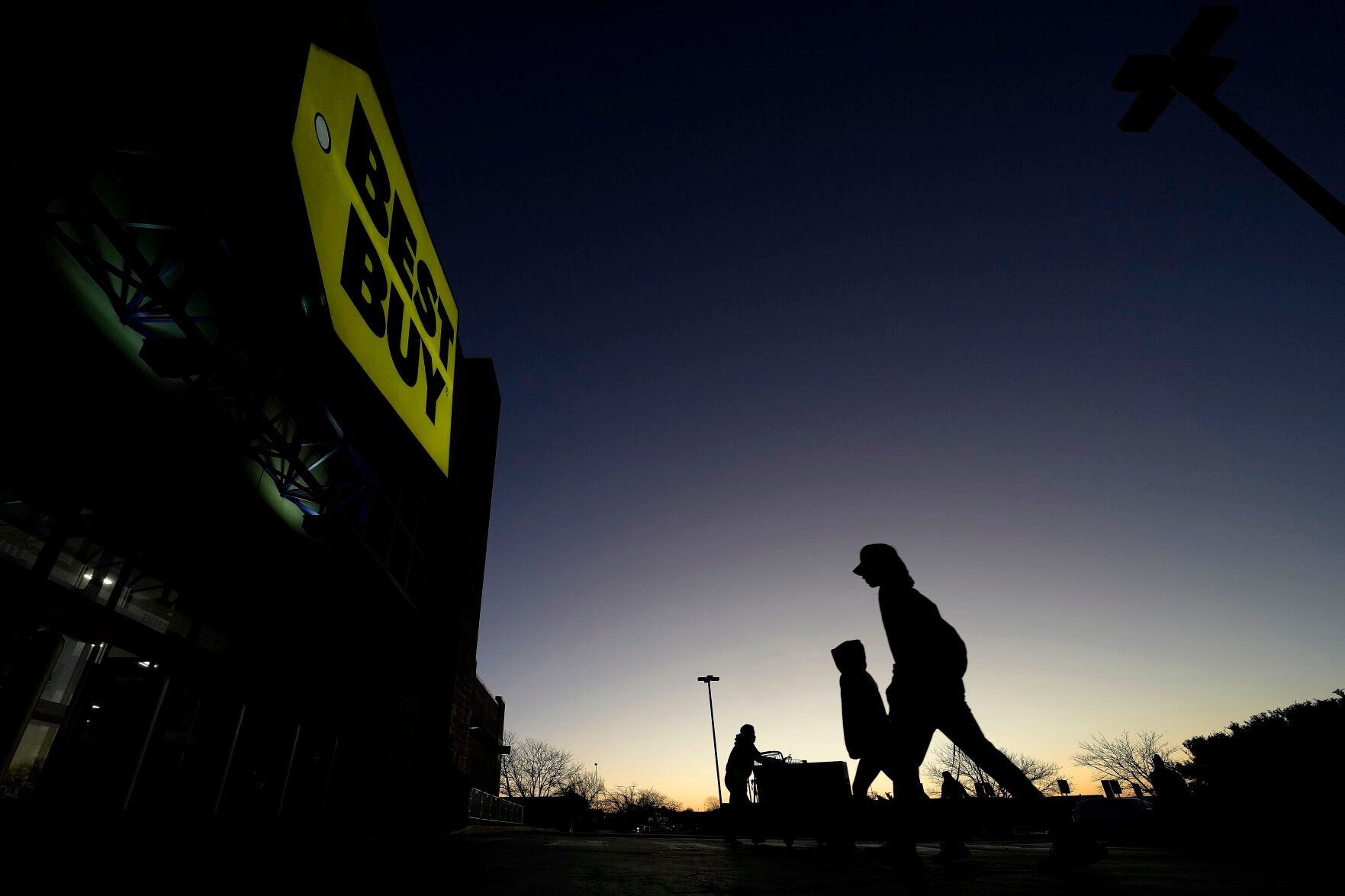 <p>FILE - Shoppers are silhouetted against the sky as they arrives for a sale at a Best Buy store Friday, Nov. 25, 2022, in Overland Park, Kan. On Friday, the Commerce Department issues its February report on consumer spending. (AP Photo/Charlie Riedel, File)</p>   PHOTO CREDIT: Charlie Riedel - staff, AP