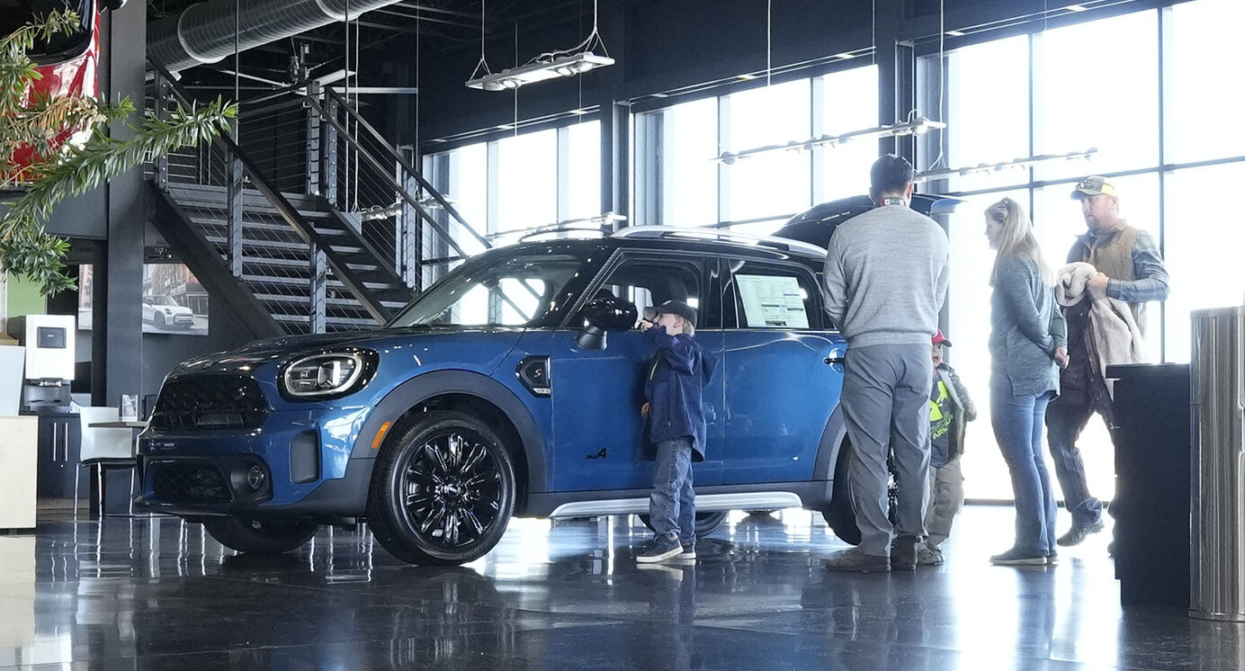 <p>File - Potential buyers look at a 2023 Cooper Countryman S sports-utility vehicle on the floor of a Mini dealership on Friday, Feb. 17, 2023, in Highlands Ranch, Colo. On Friday, the Commerce Department issues its February report on consumer spending. (AP Photo/David Zalubowski, File)</p>   PHOTO CREDIT: David Zalubowski - staff, AP