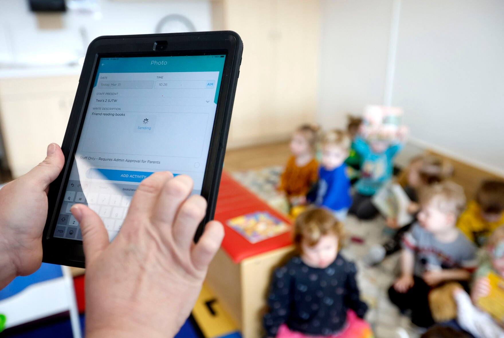 Pauline Brimeyer, a lead teacher, sends an update for her 2-year-olds’ class using the Procare app at St. Joseph the Worker Early Childhood Center.    PHOTO CREDIT: JESSICA REILLY
Telegraph Herald