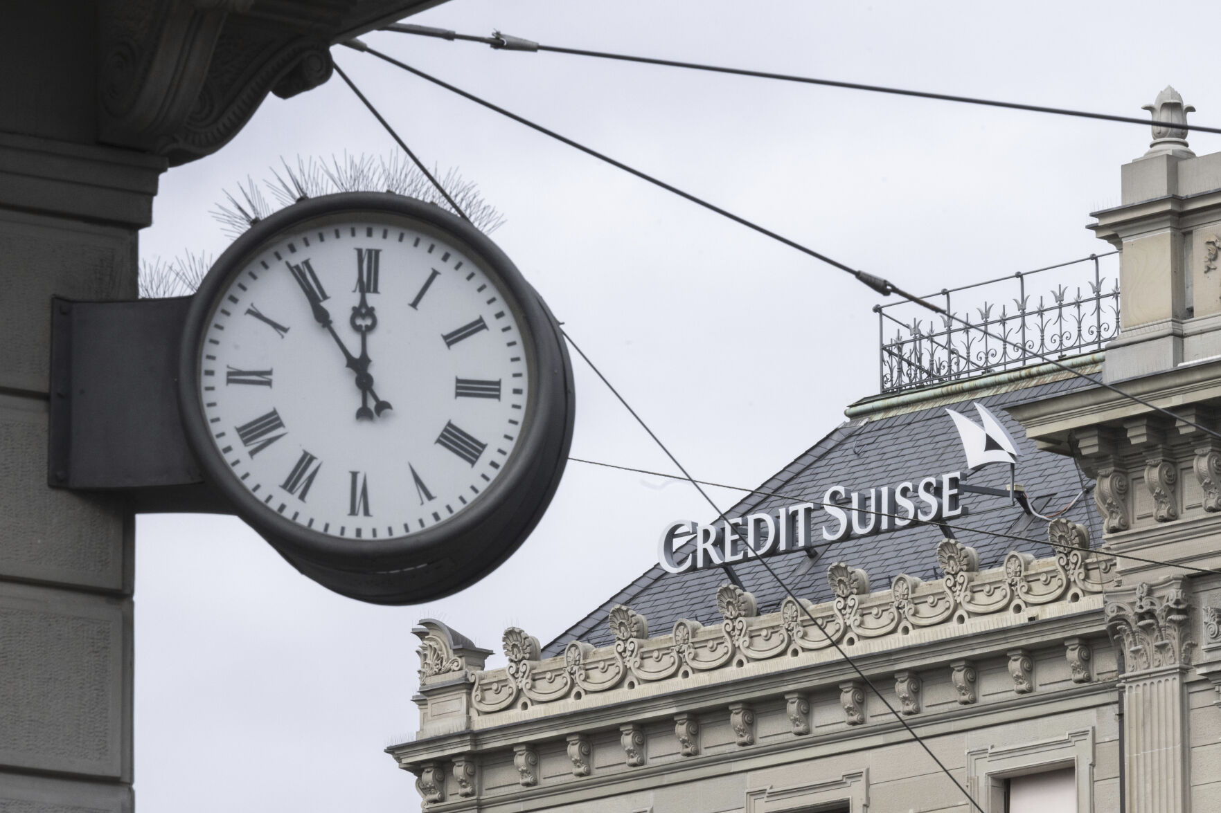 <p>FILE - A clock next to a logo of the Swiss bank Credit Suisse, in Zurich, Switzerland, on March 20, 2023. Analysts say the UBS takeover of embattled rival Credit Suisse has shaken Switzerland’s self-image and dented its reputation as a global financial center. They warn that the country’s prosperity could grow too dependent on a single banking behemoth. (Ennio Leanza/Keystone via AP, File)</p>   PHOTO CREDIT: Ennio Leanza