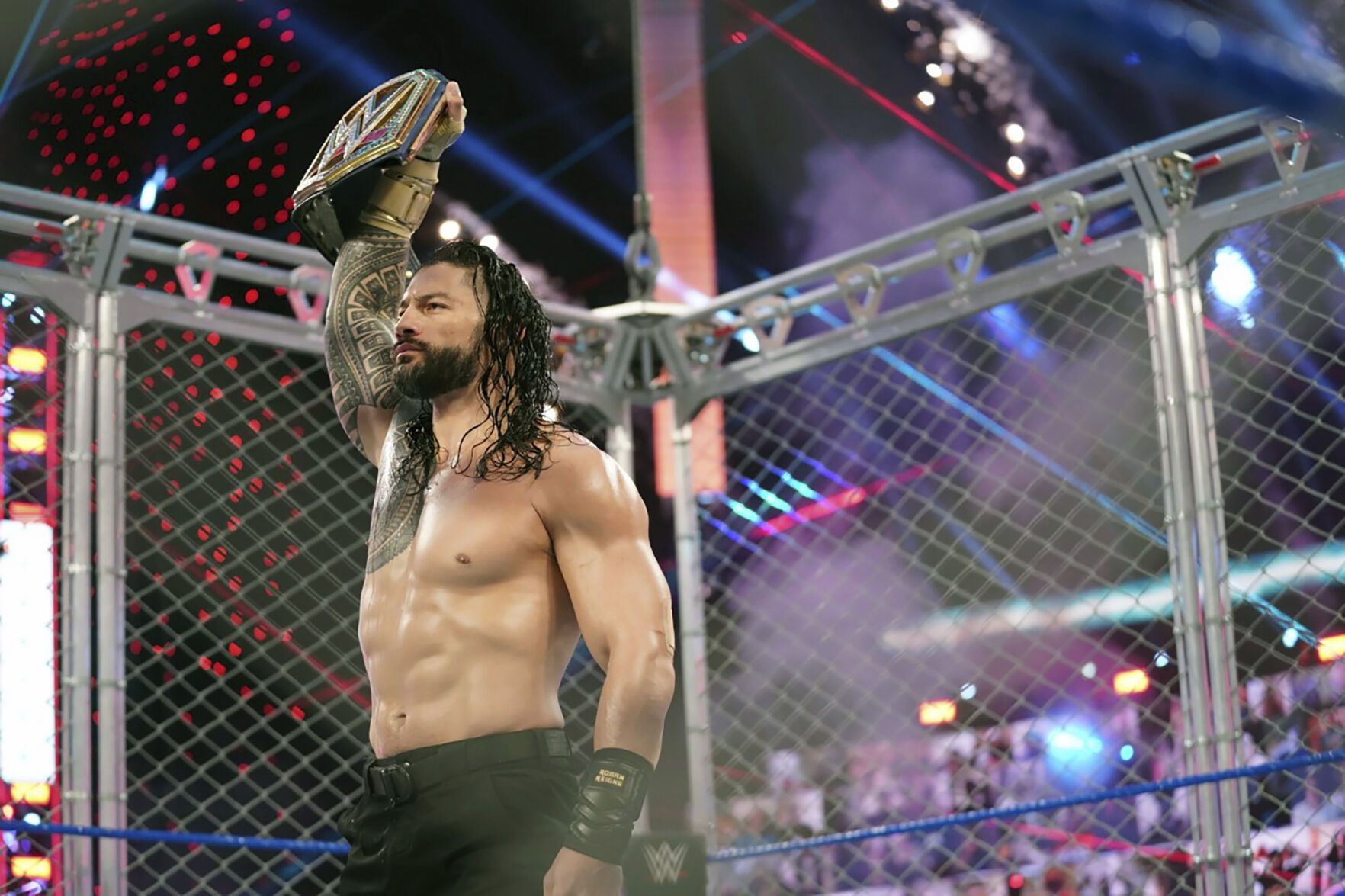 <p>Roman Reigns holds up the WWE Universal Championship after defeating Jey Uso during a match on Oct. 25, 2020, in Orlando, Florida. Reigns and Cody Rhodes will be in the main event of WrestleMania 39 on April 2, 2023, in Los Angeles. (WWE via AP)</p>   PHOTO CREDIT: WWE