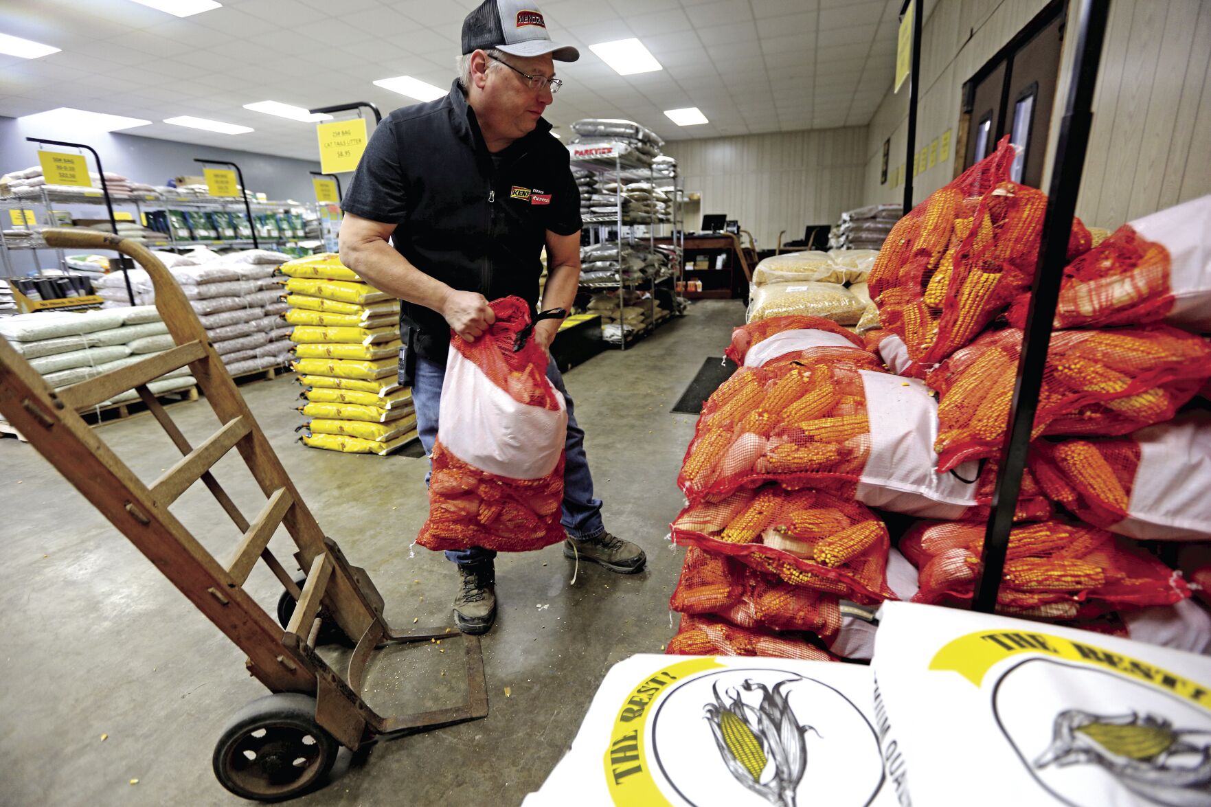 Hendricks Feed & Seed owner Rodney Schroeder moves inventory Thursday at the company’s new home at 2040 Kerper Blvd. The business moved from Central Avenue to make room for a parking ramp.    PHOTO CREDIT: Dave Kettering