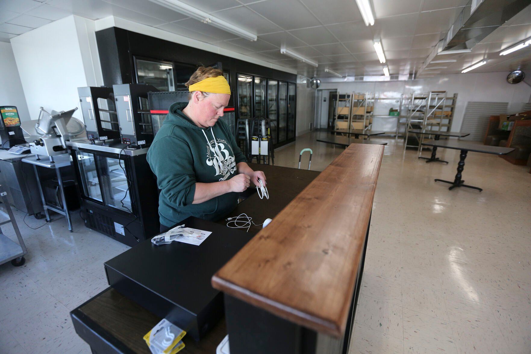 Erin Potter, co-owner of Buenie Bottoms Grill & Market, works on the inside of the new business in Holy Cross, Iowa, on April 10, 2023.    PHOTO CREDIT: Dave Kettering