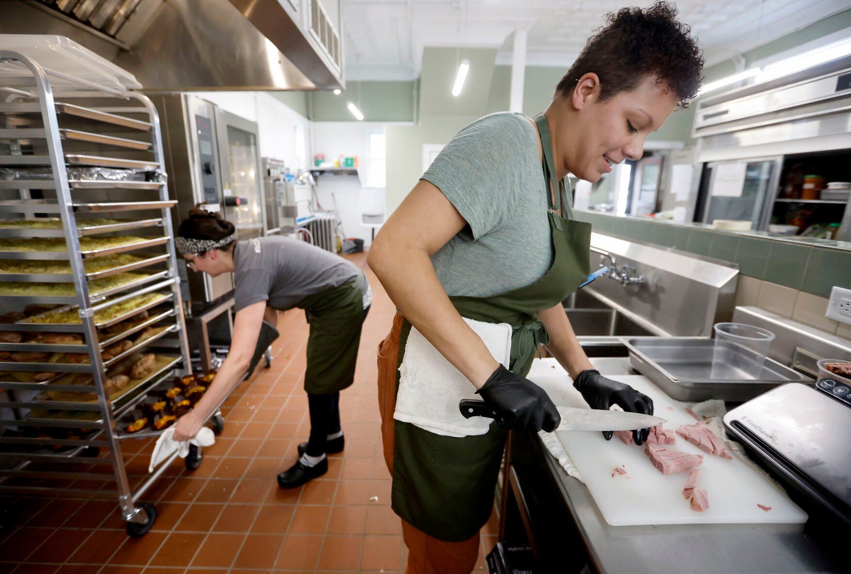Owner Justyna Miranda (left) and Joy Klaren prepare meals at City Girl Farming in Dubuque on Tuesday, April 11, 2023.    PHOTO CREDIT: JESSICA REILLY