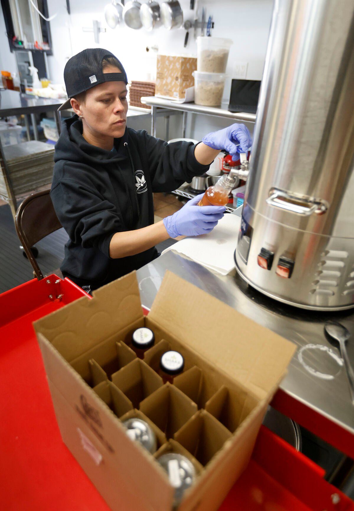 Shawna Dole fills bottles with product at River Bluff Collective in East Dubuque, Ill., on Thursday, April 13, 2023.    PHOTO CREDIT: JESSICA REILLY
Telegraph Herald