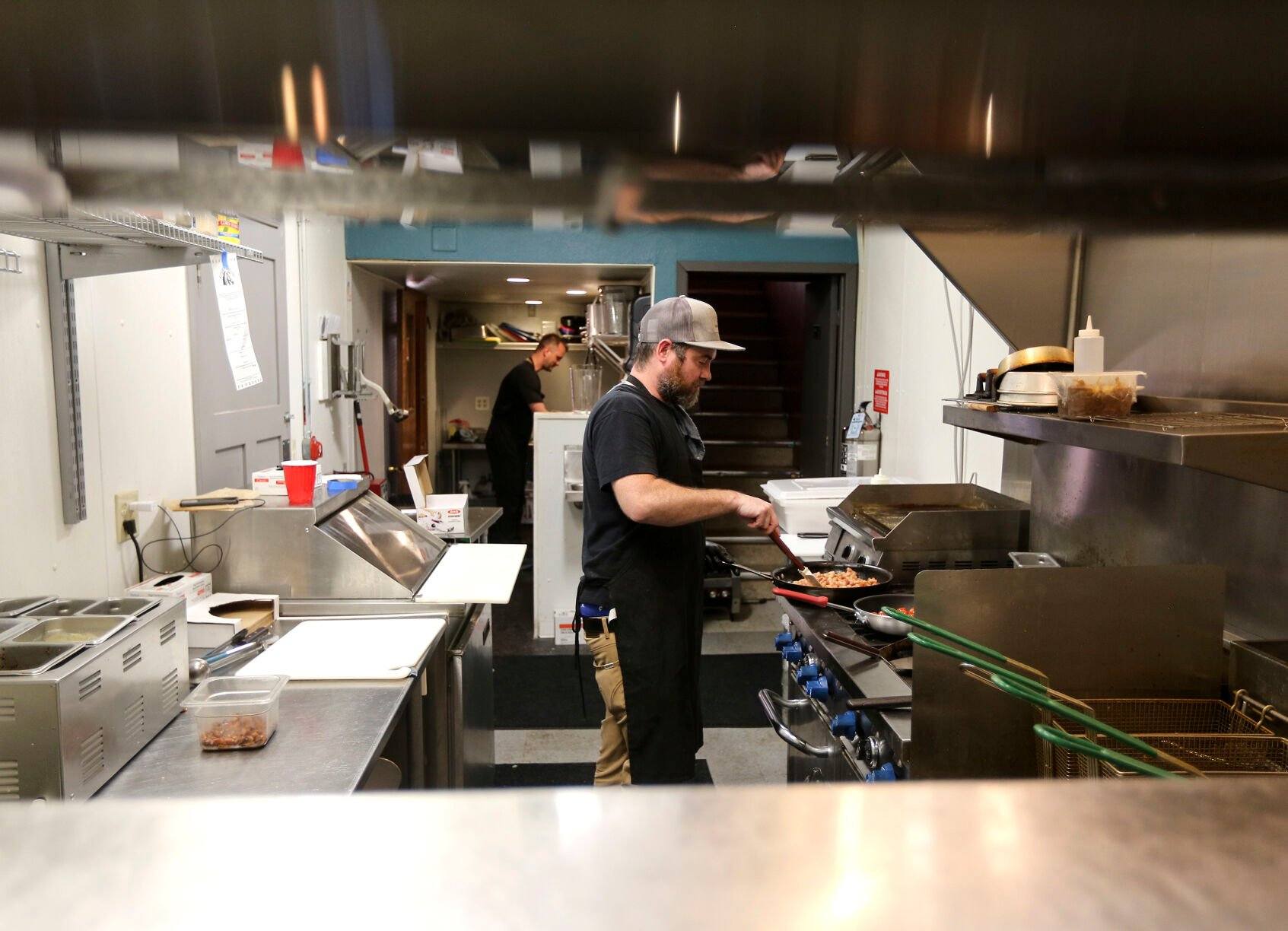 Nate Ternes who is the head chef at the Kitchen Brigade cooks food in the kitchen of the Fox Den Motel on Friday, April 14, 2023.    PHOTO CREDIT: Dave Kettering
