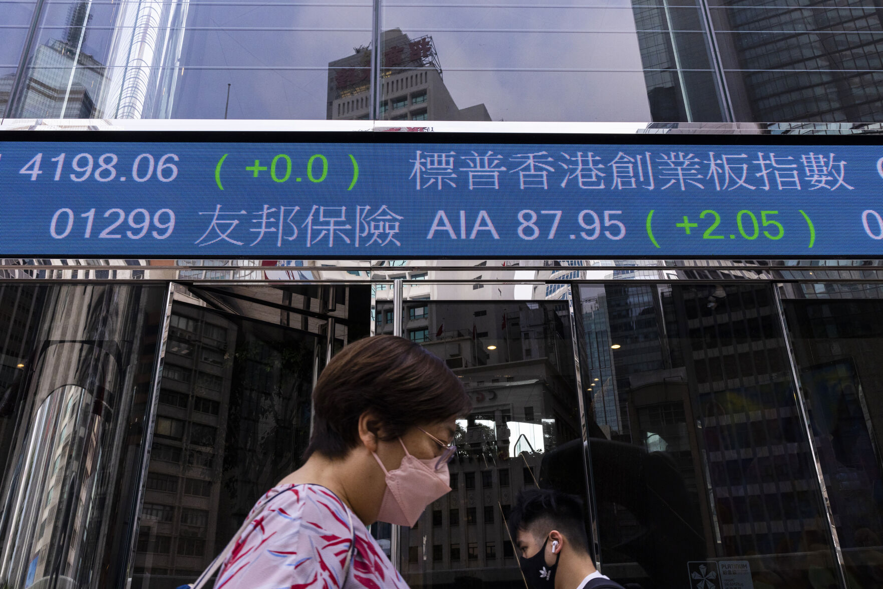 <p>Pedestrians pass by the Hong Kong Stock Exchange electronic screen in Hong Kong, Tuesday, April 18, 2023. Asian shares were trading mixed Tuesday as pessimism about global uncertainties remained even as China reported a better-than-expected economic growth data. (AP Photo/Louise Delmotte)</p>   PHOTO CREDIT: Louise Delmotte - staff, AP