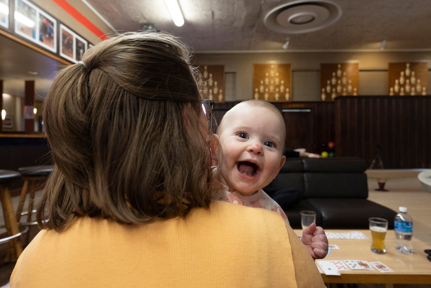 Ruth Carlson holds daughter Gianna, 7 months, during an evening of bowling at Fischer Lanes in Dubuque on Thursday, May 4, 2023.    PHOTO CREDIT: Stephen Gassman
Telegraph Herald