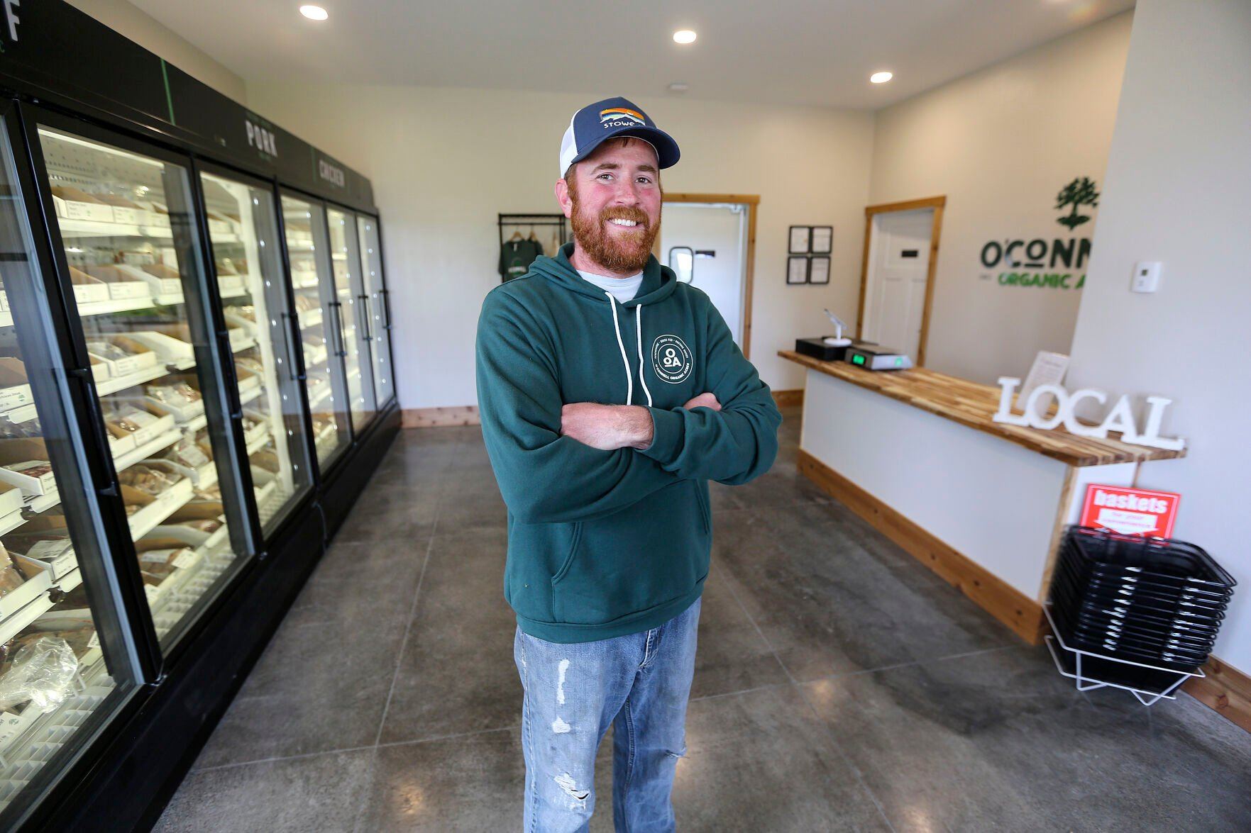 Chris O’Connell, owner of O’Connell Organic Acres near Durango, Iowa, stands inside his new storefront.    PHOTO CREDIT: Dave Kettering
