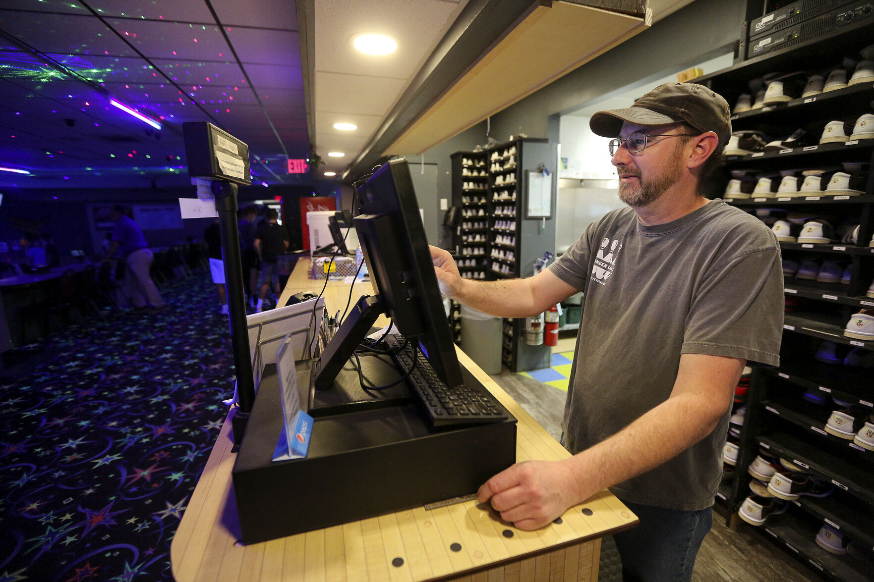 Pioneer Lanes owner Joe Haack checks in customers recently at the business located in Platteville, Wis.    PHOTO CREDIT: Dave Kettering
Telegraph Herald