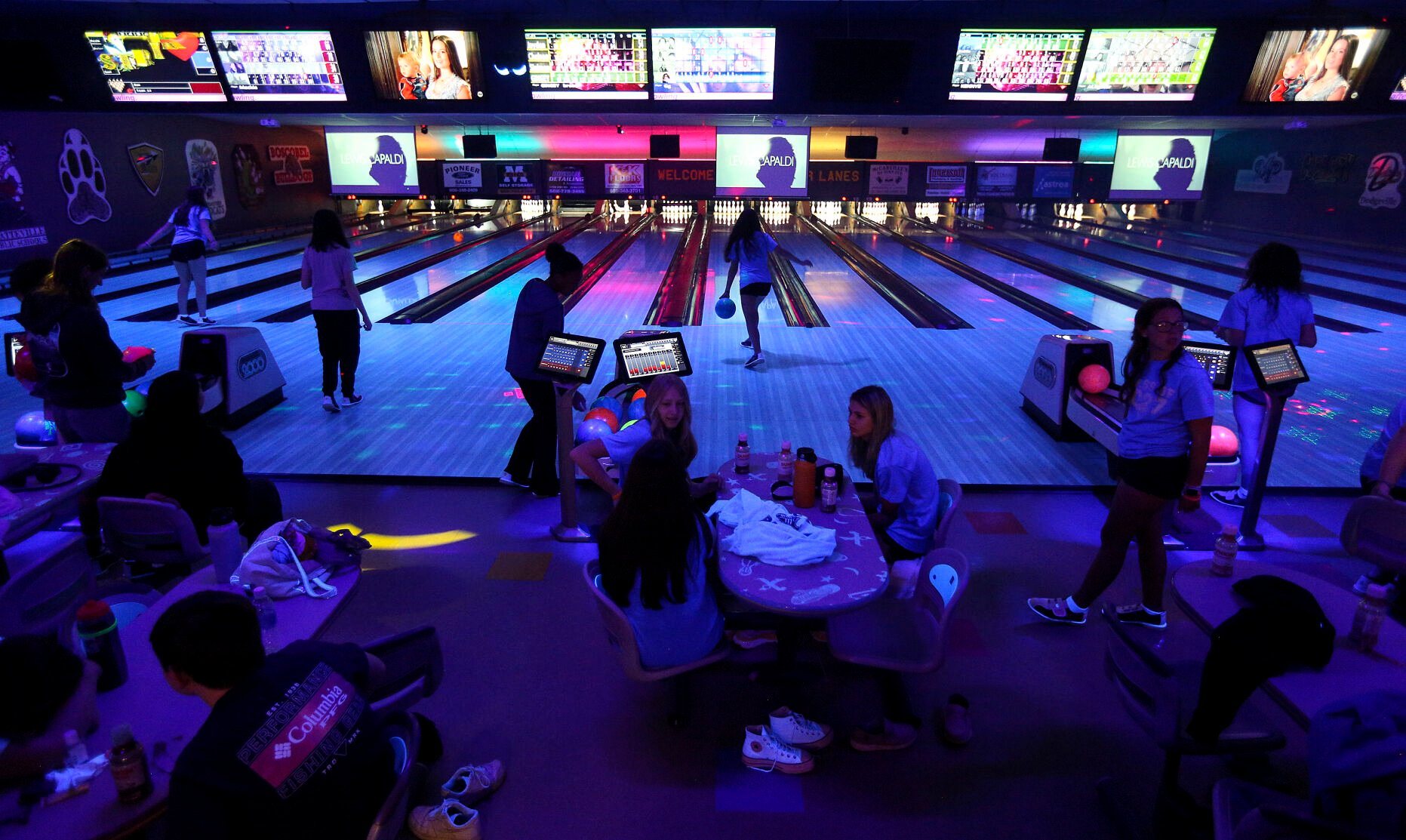 Galena Middle School students take part in cosmic bowling at Pioneer Lanes in Platteville, Wis., recently. While league bowling remains prevalent at area lanes, owners of longtime, locally owned bowling alleys have increased efforts to attract casual bowlers to help boost business as industry pressures strain alleys nationwide.    PHOTO CREDIT: Dave Kettering
Telegraph Herald
