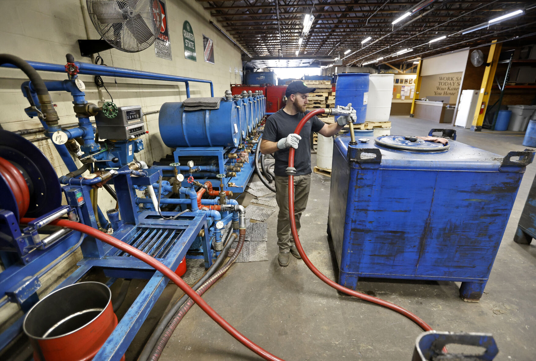 Preston Anderson fills containers with oil at Rainbo Oil Co. in Dubuque on Tuesday, May 16, 2023.    PHOTO CREDIT: JESSICA REILLY
Telegraph Herald