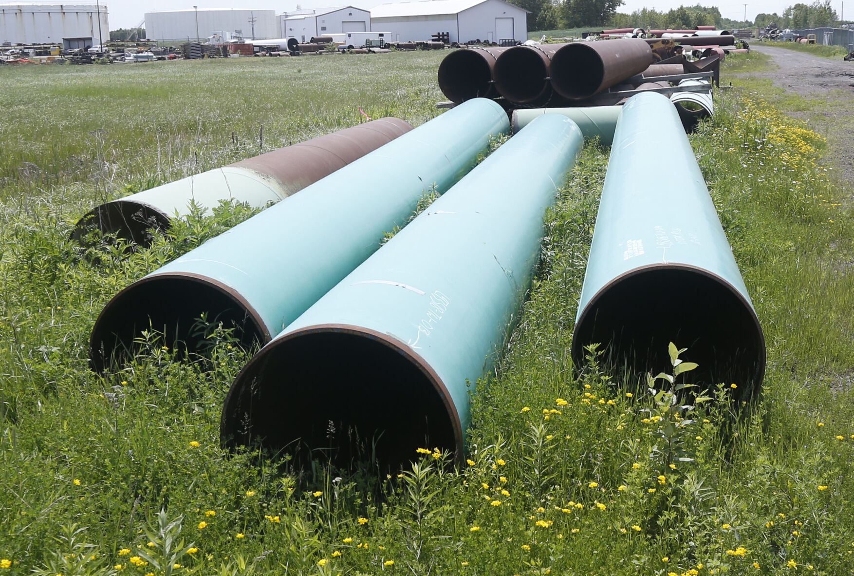 <p>FILE - Pipeline used to carry crude oil sits at the Superior, Wis., terminal of Enbridge Energy, June 29, 2018. Attorneys for a Wisconsin Native American tribe are set to argue Thursday, May 18, 2023, that a federal judge should order an energy company to shut down an oil pipeline the tribe says is at immediate risk of being exposed by erosion and rupturing on reservation land. (AP Photo/Jim Mone, File)</p>   PHOTO CREDIT: Jim Mone